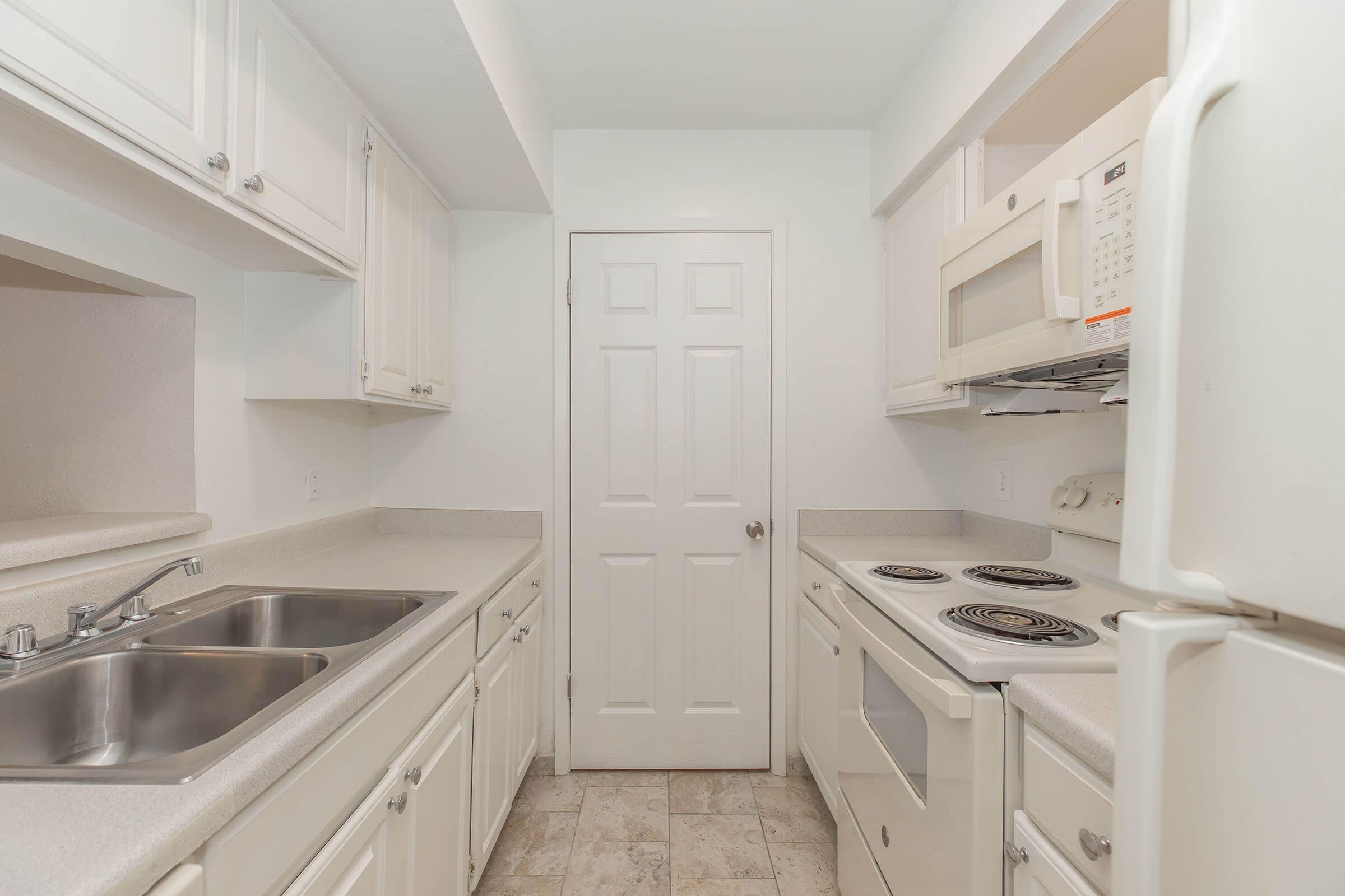 a stove top oven sitting inside of a kitchen