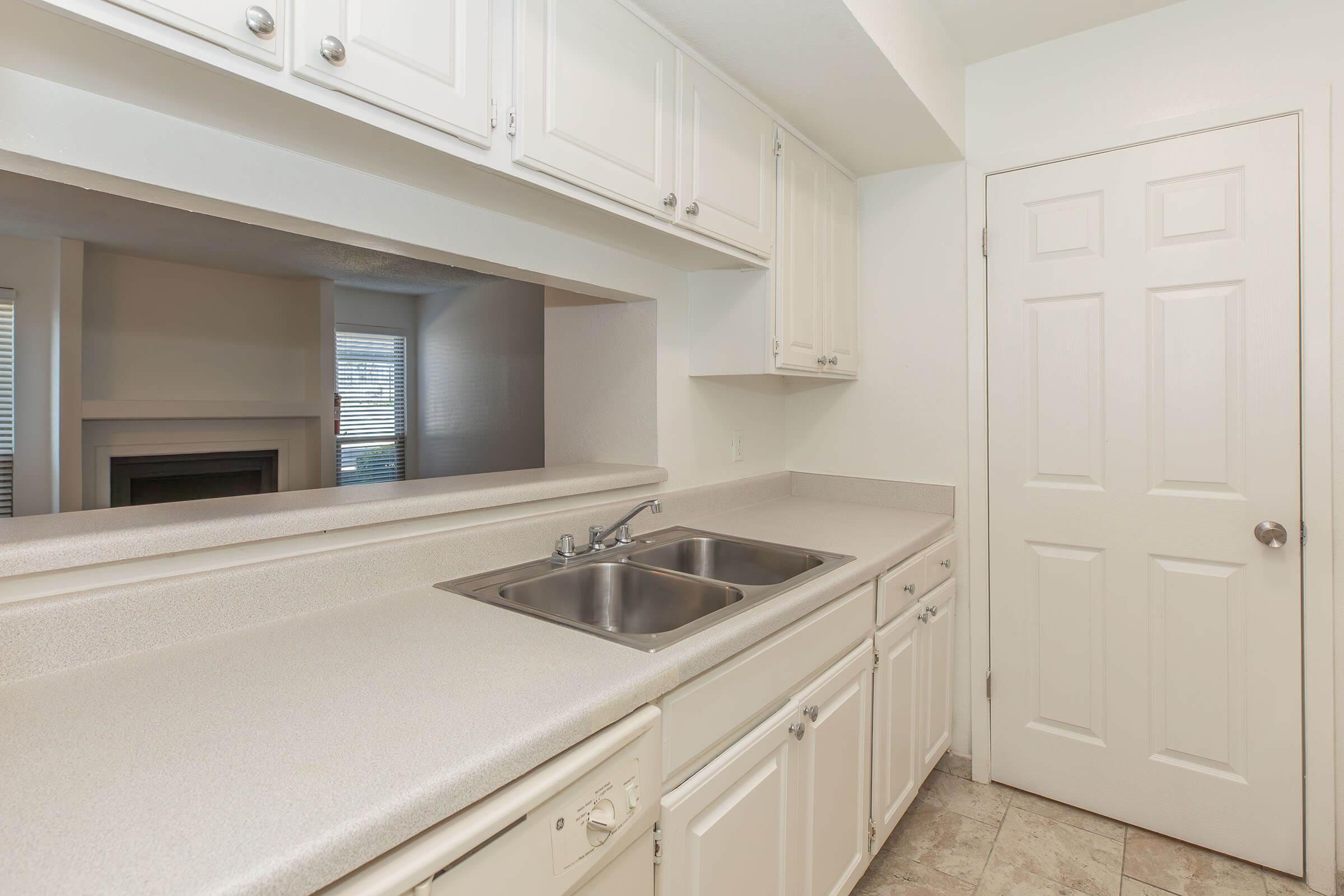 a kitchen with a sink and a window