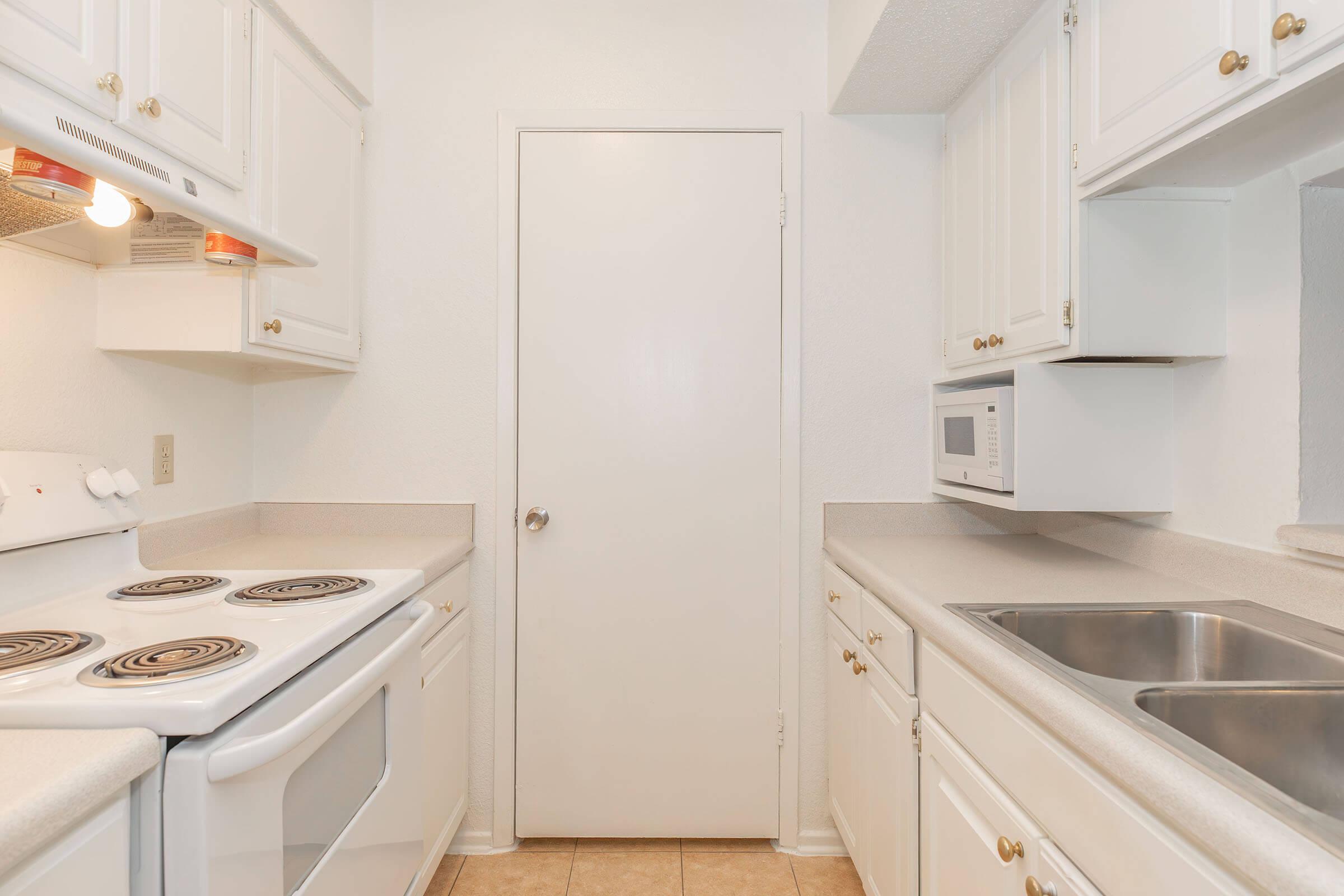 a stove top oven sitting inside of a kitchen