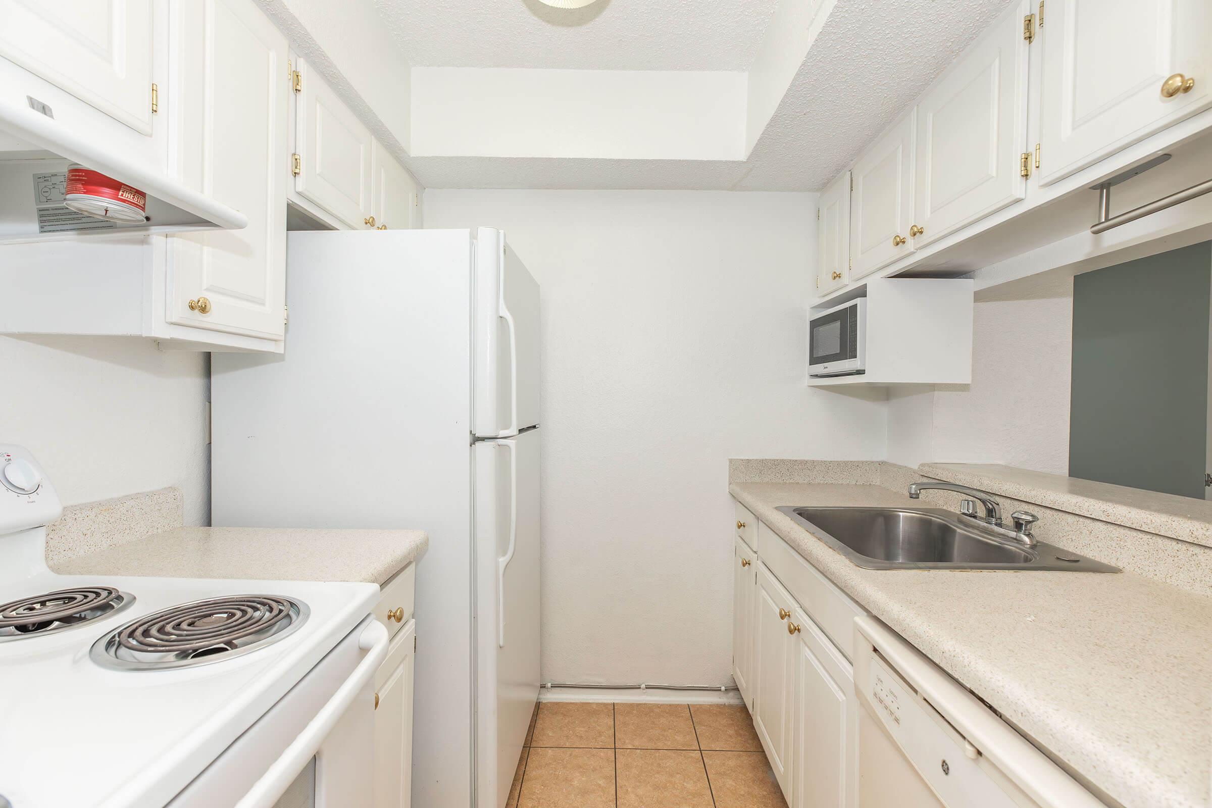 a stove top oven sitting inside of a kitchen