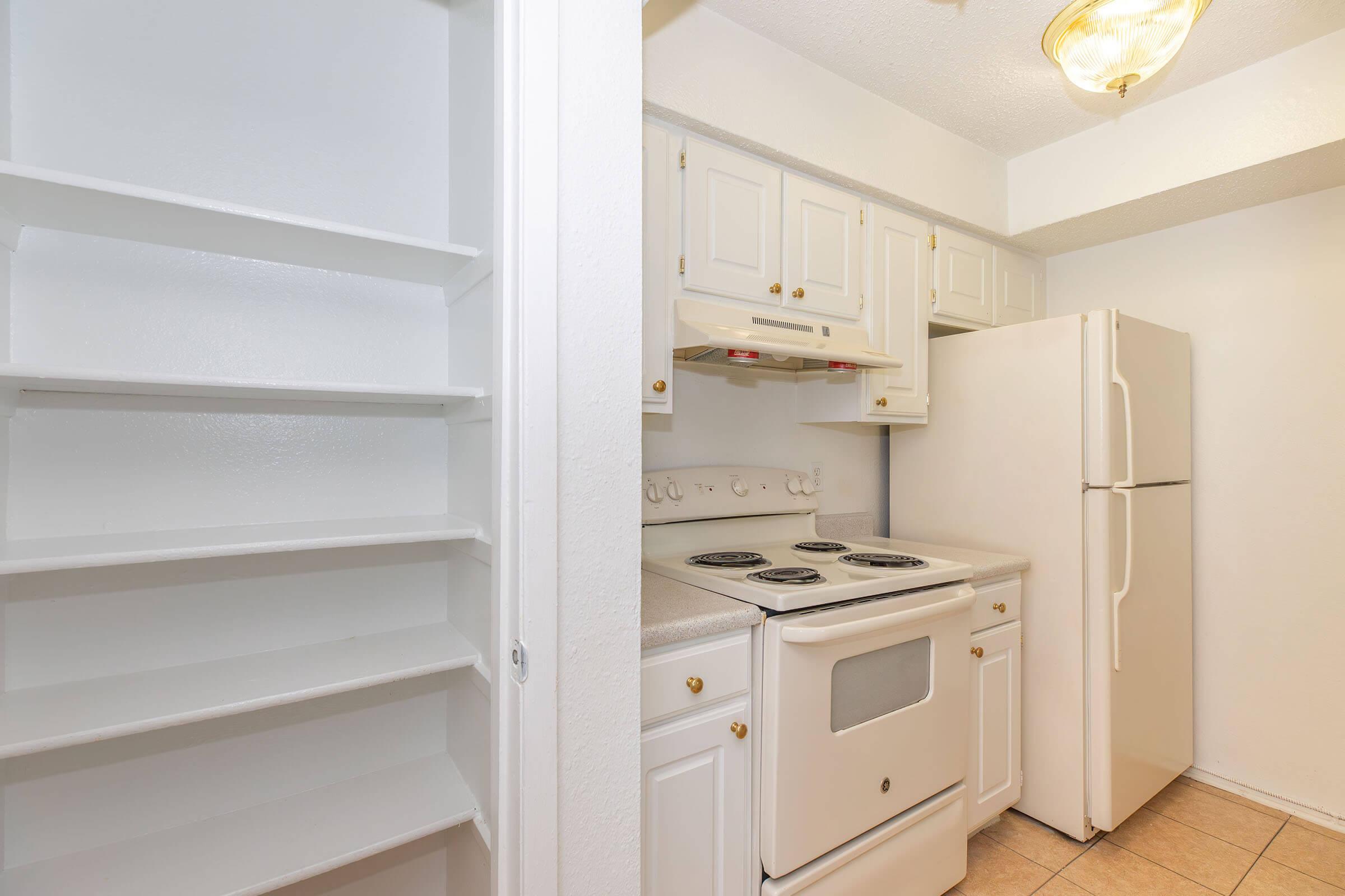 a kitchen with a stove top oven sitting inside of a refrigerator