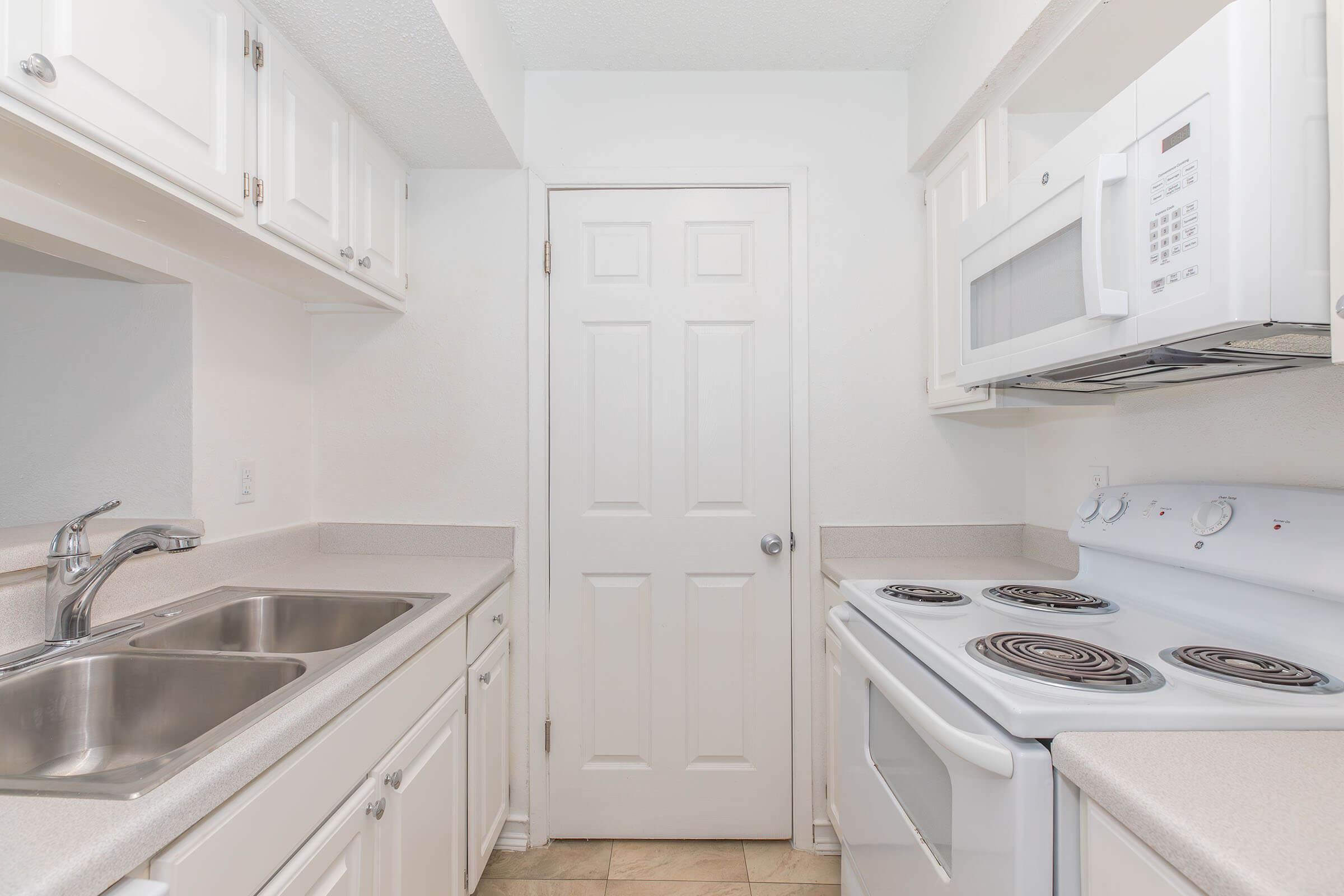 a stove top oven sitting inside of a kitchen