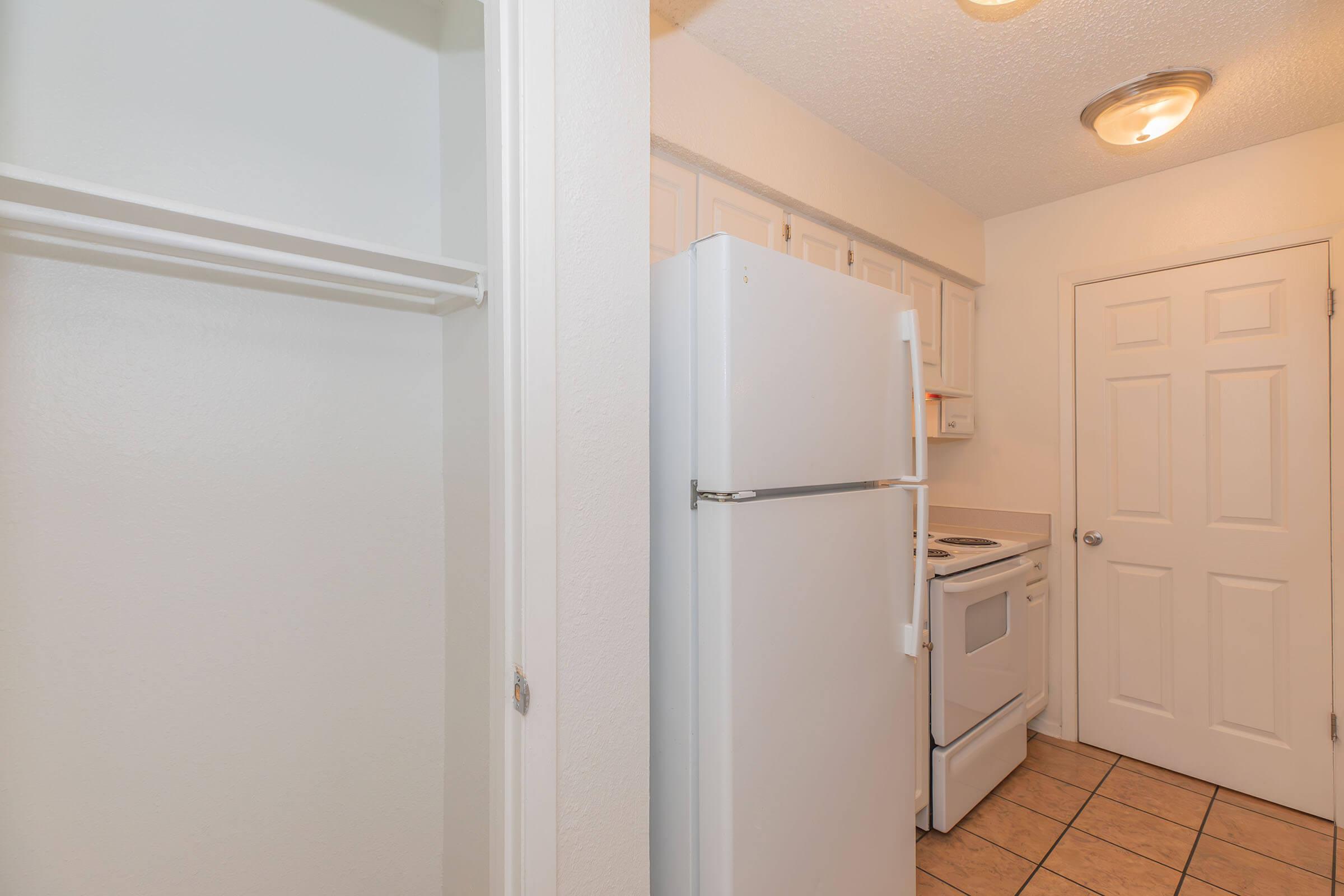 a kitchen with a sink and a refrigerator