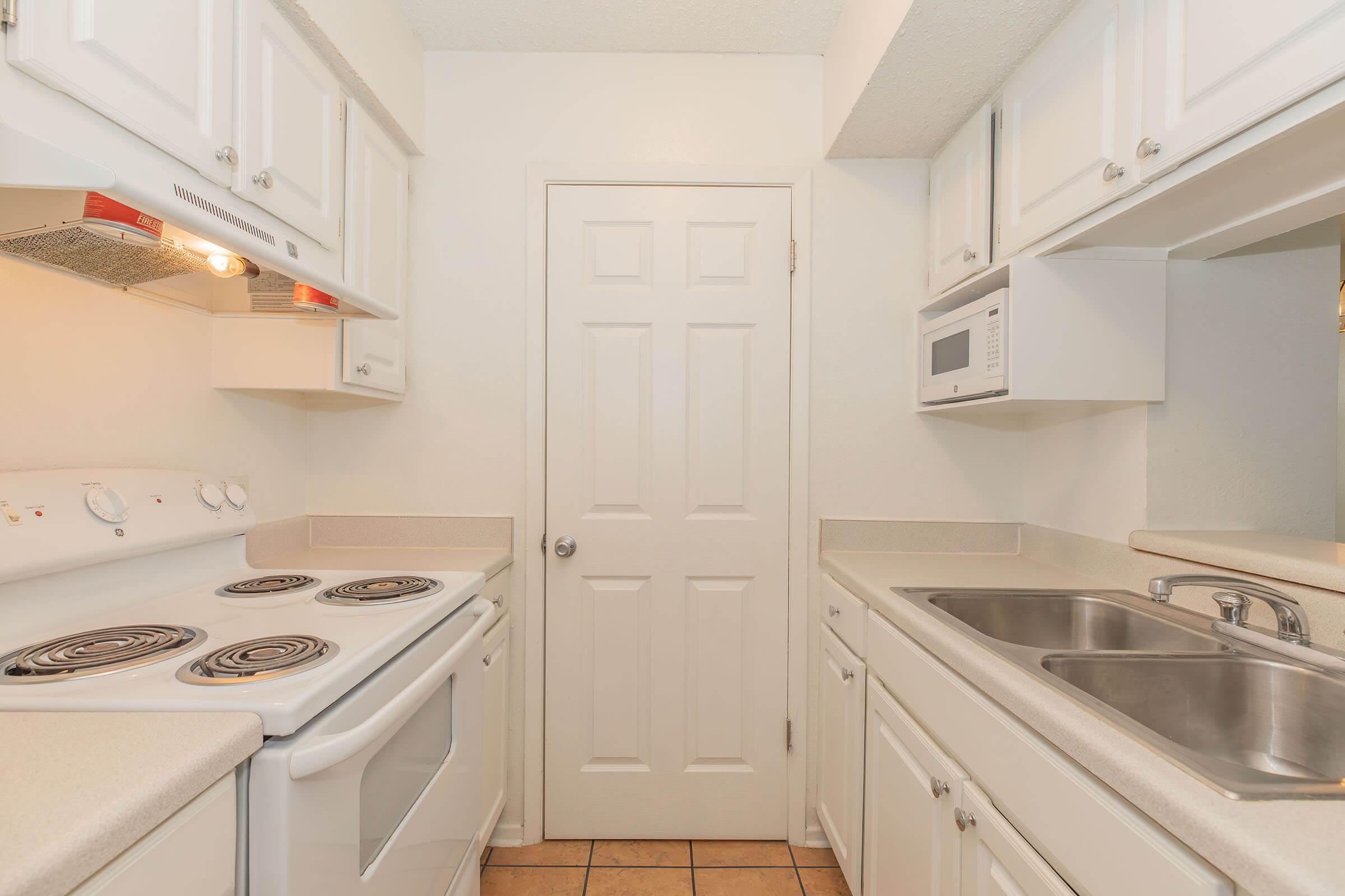 a stove top oven sitting inside of a kitchen