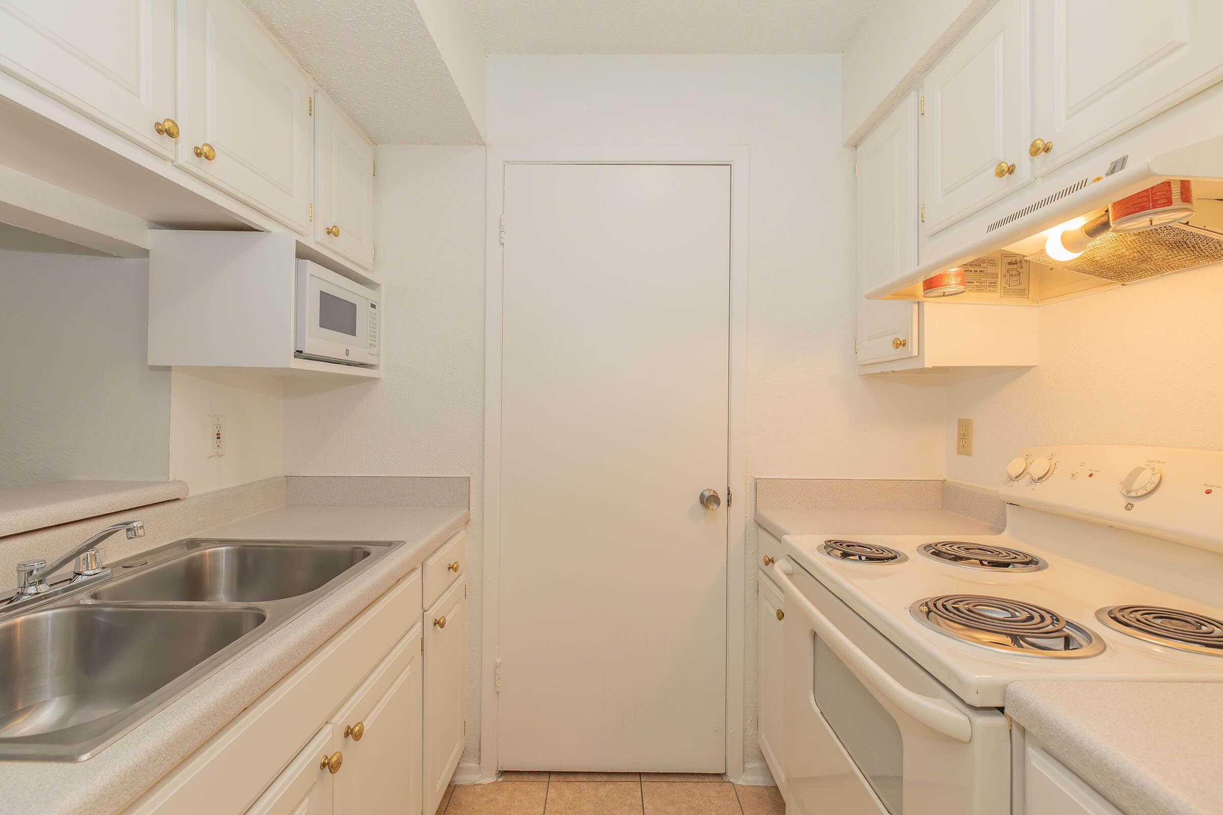 a stove top oven sitting inside of a kitchen