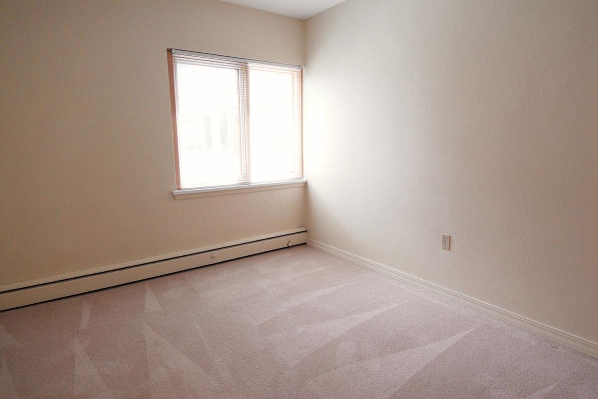 a bedroom with a bed and a mirror