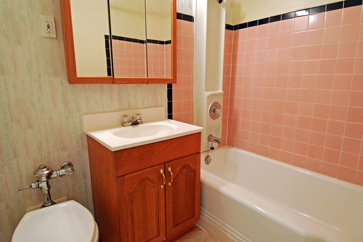 a white tub sitting next to a sink