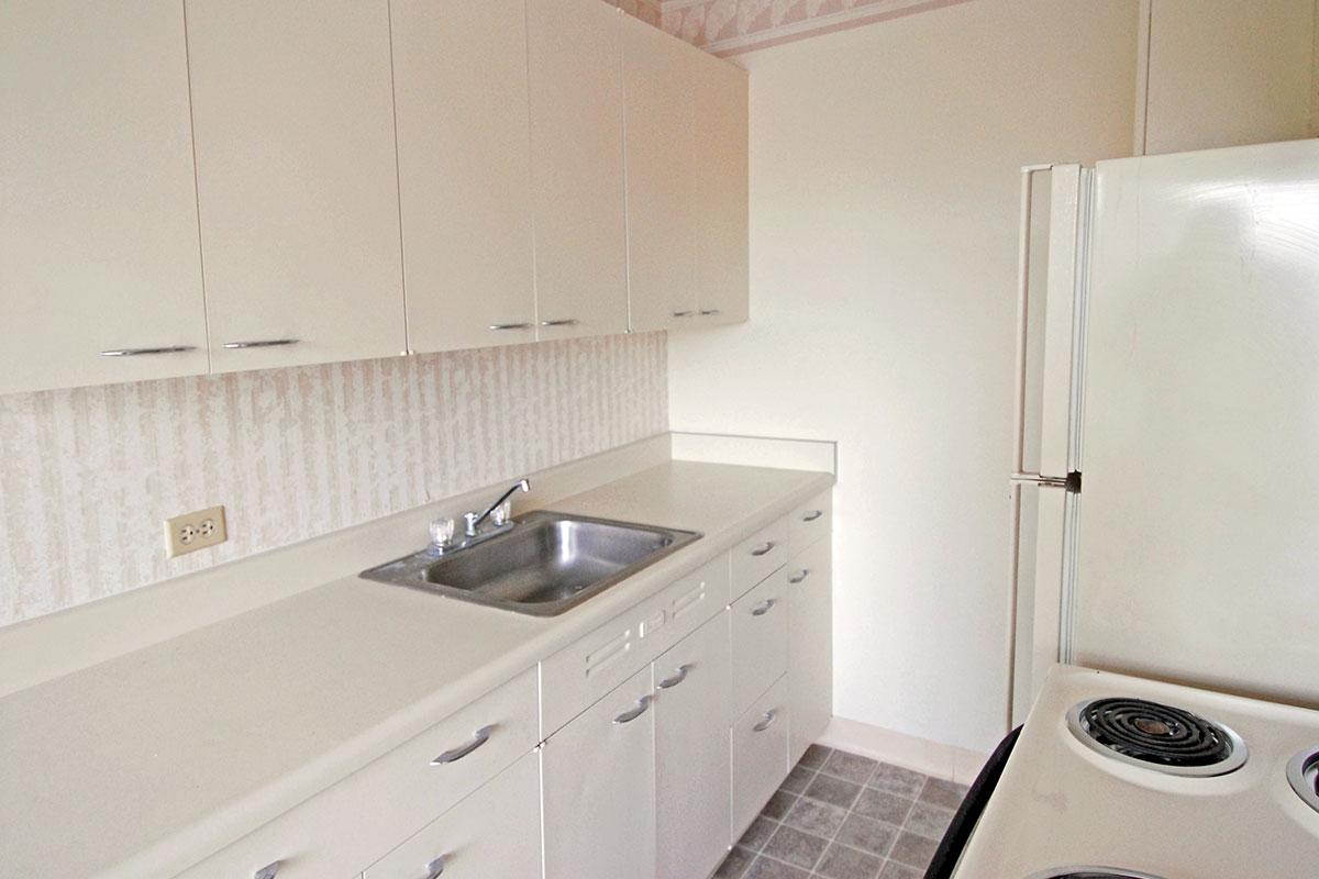 a white stove top oven sitting inside of a kitchen