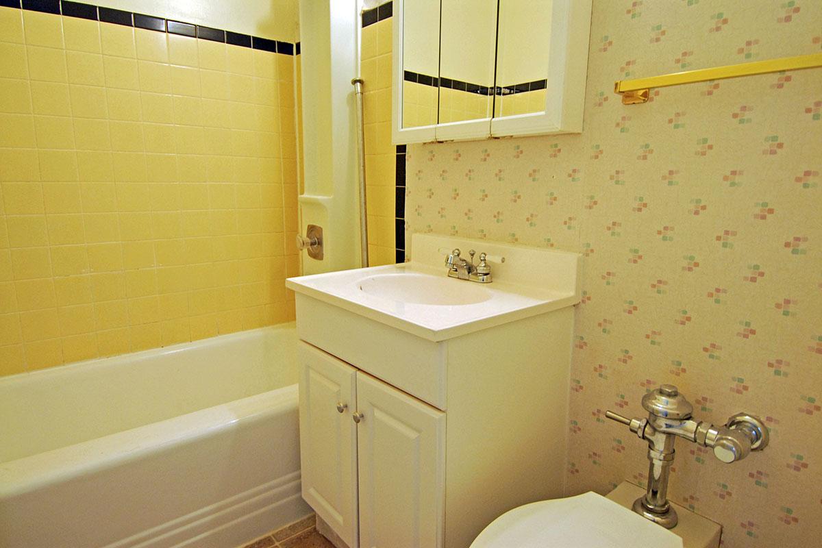 a room with a sink and a mirror