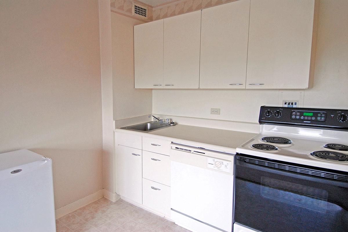 a white stove top oven sitting inside of a kitchen