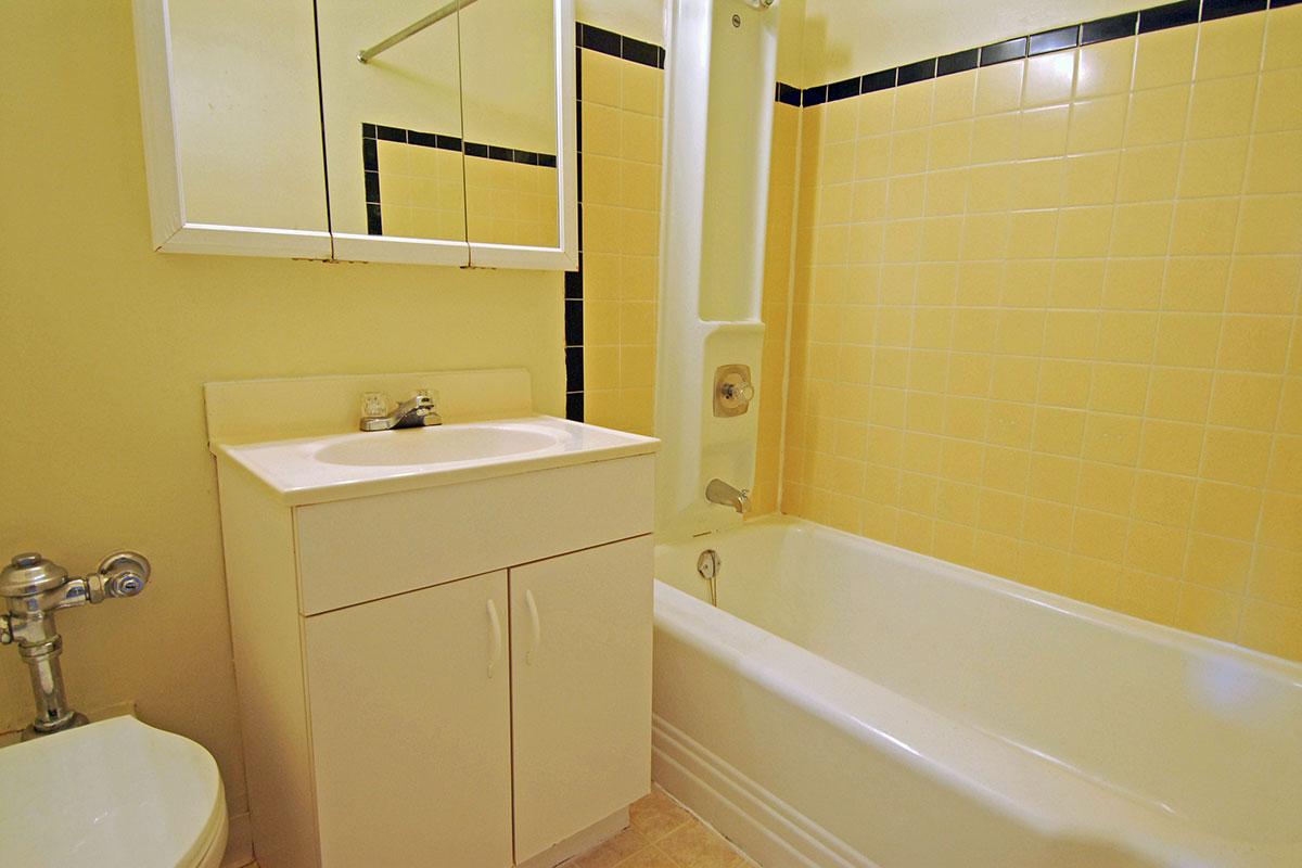 a white tub sitting next to a sink