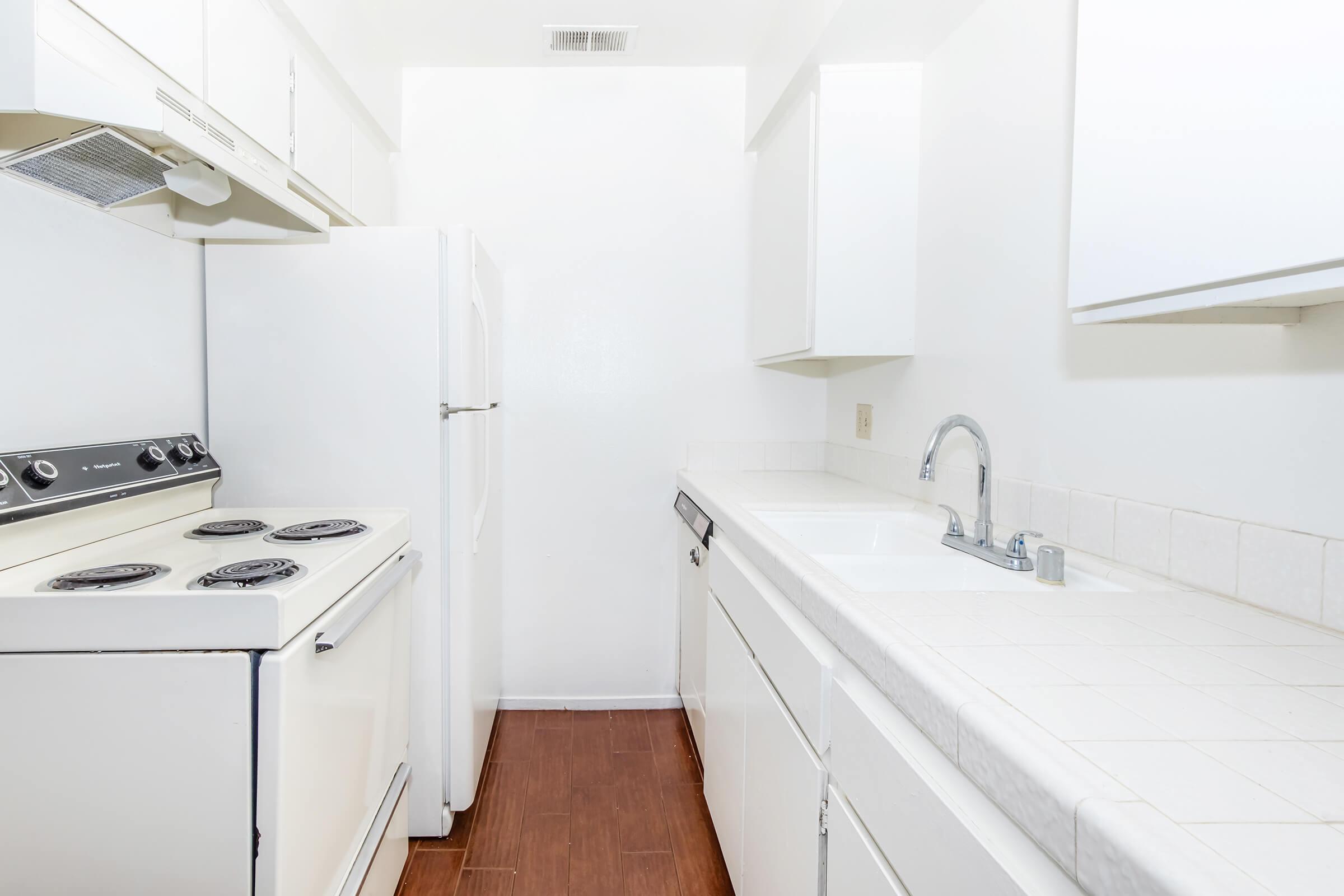 a stove top oven sitting inside of a kitchen