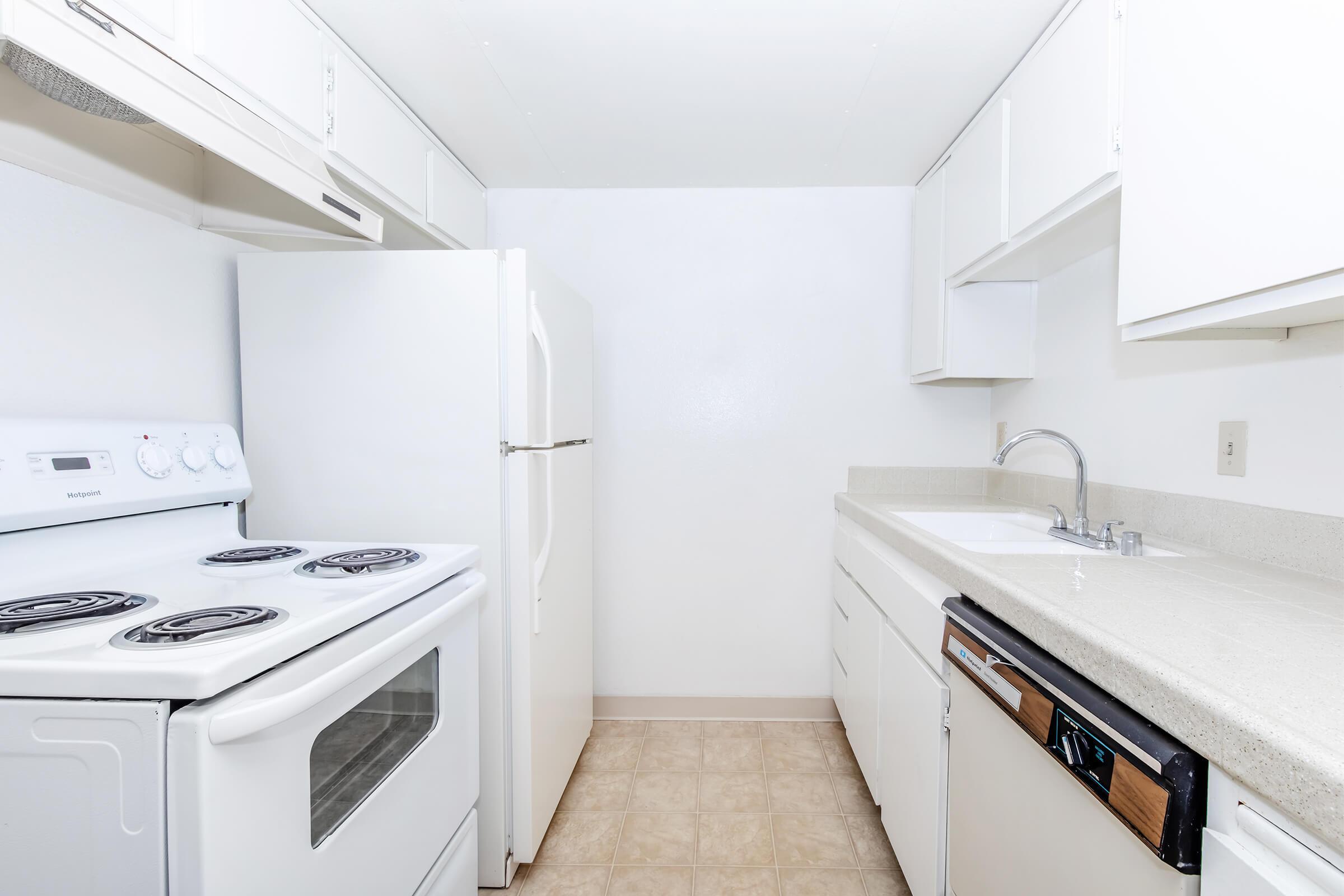 a stove top oven sitting inside of a kitchen