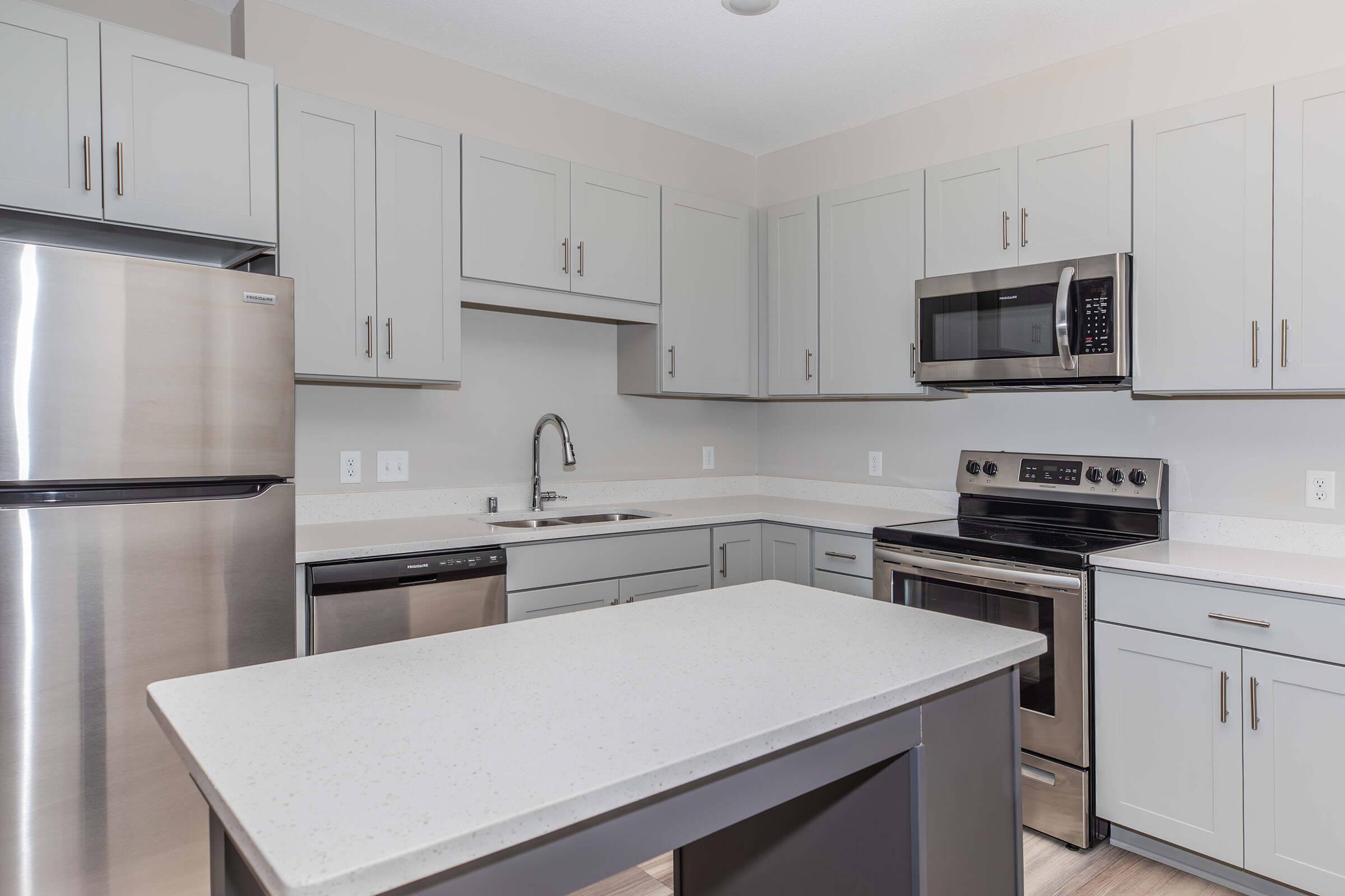 a kitchen with a sink and a microwave