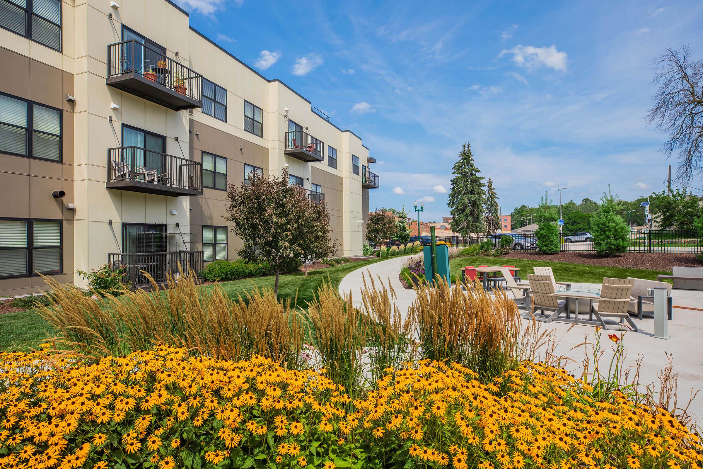 a close up of a flower garden in front of a building