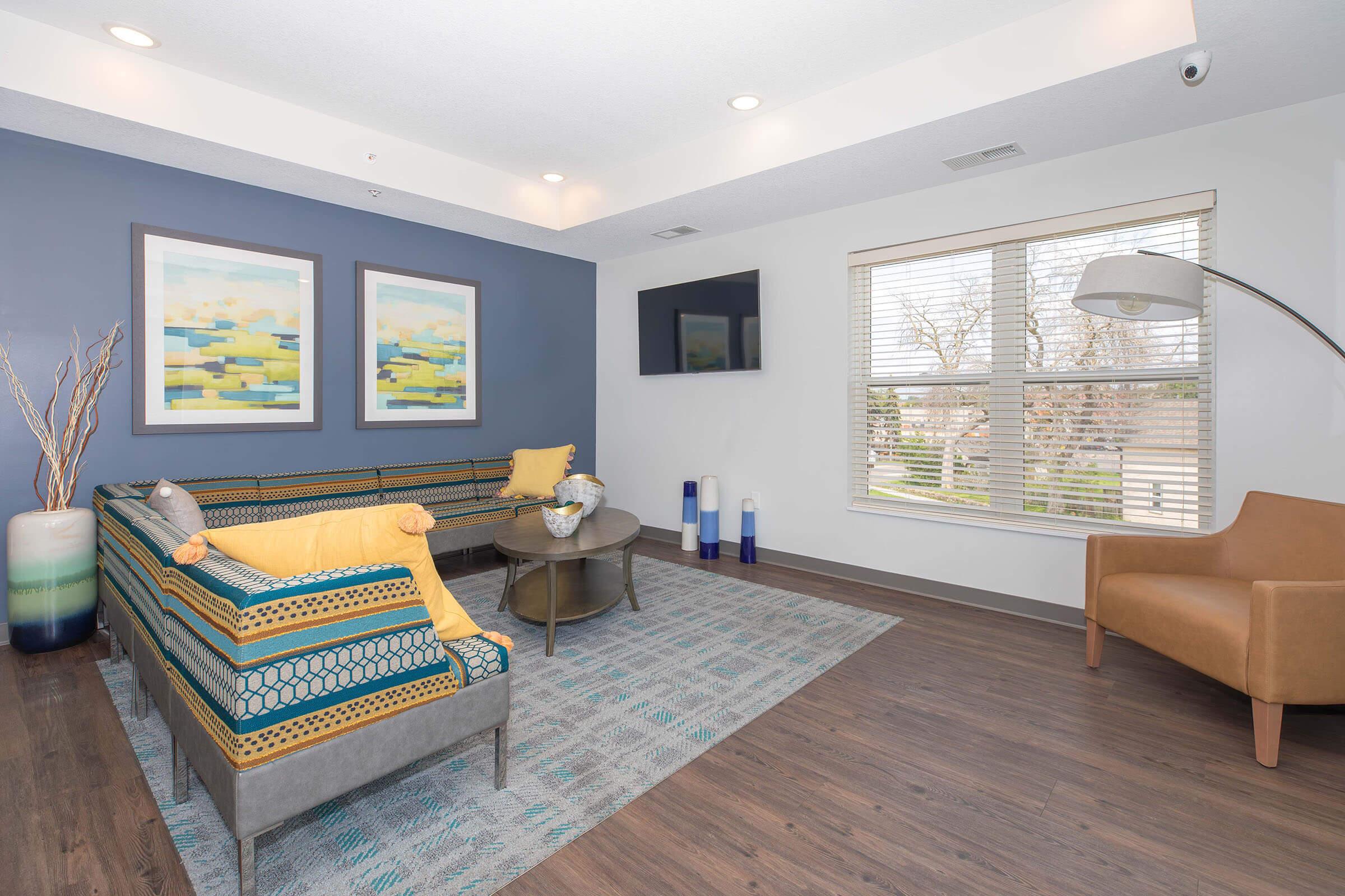 a living room filled with furniture and a large window