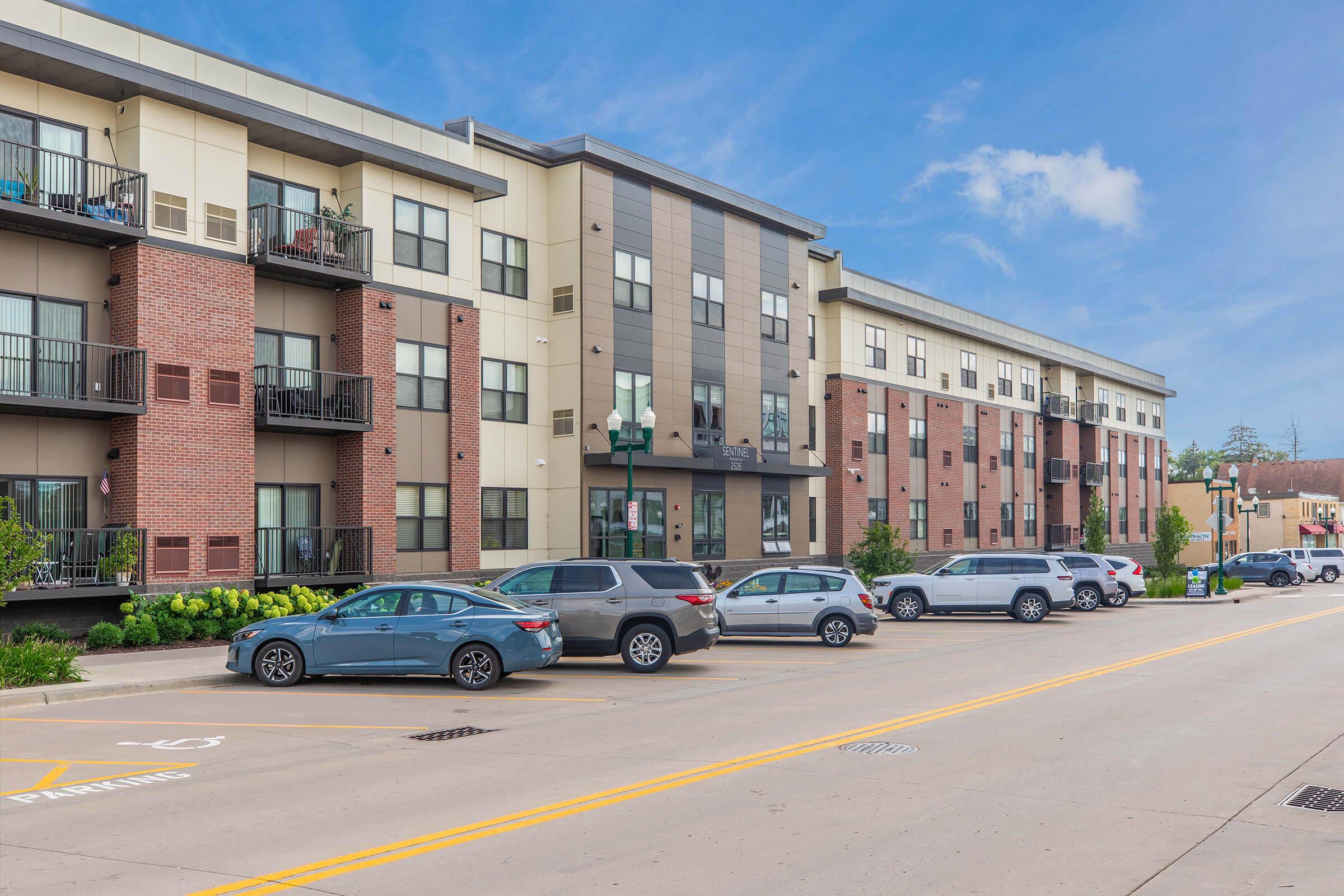 a street with cars parked on the side of a building