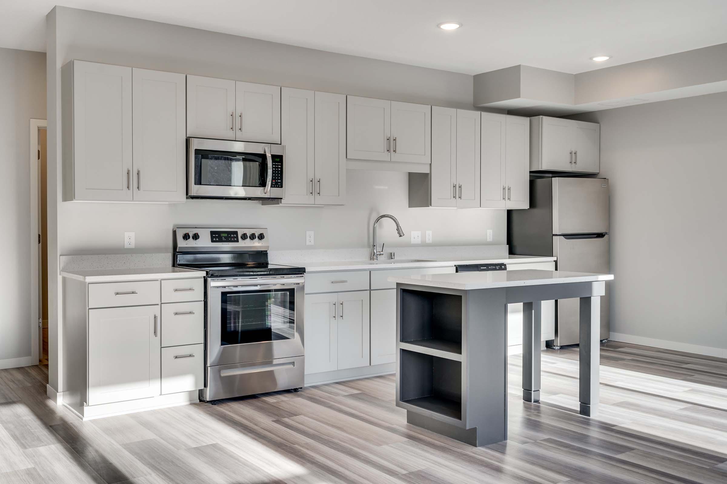 a kitchen with a stove and a refrigerator