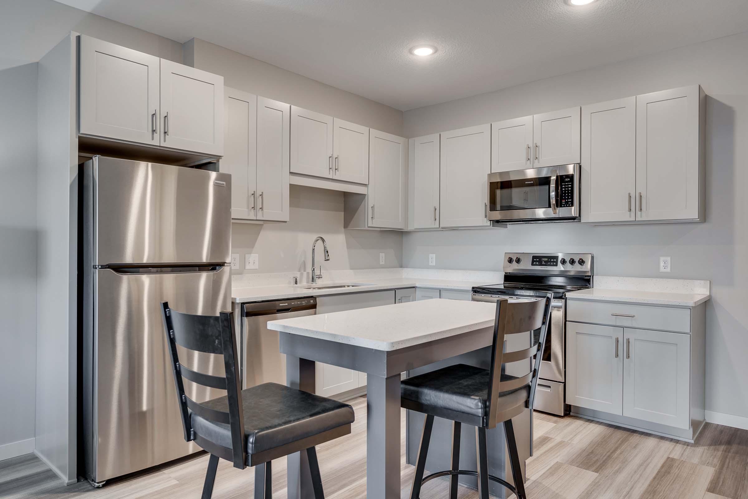 a kitchen with stainless steel appliances and wooden cabinets