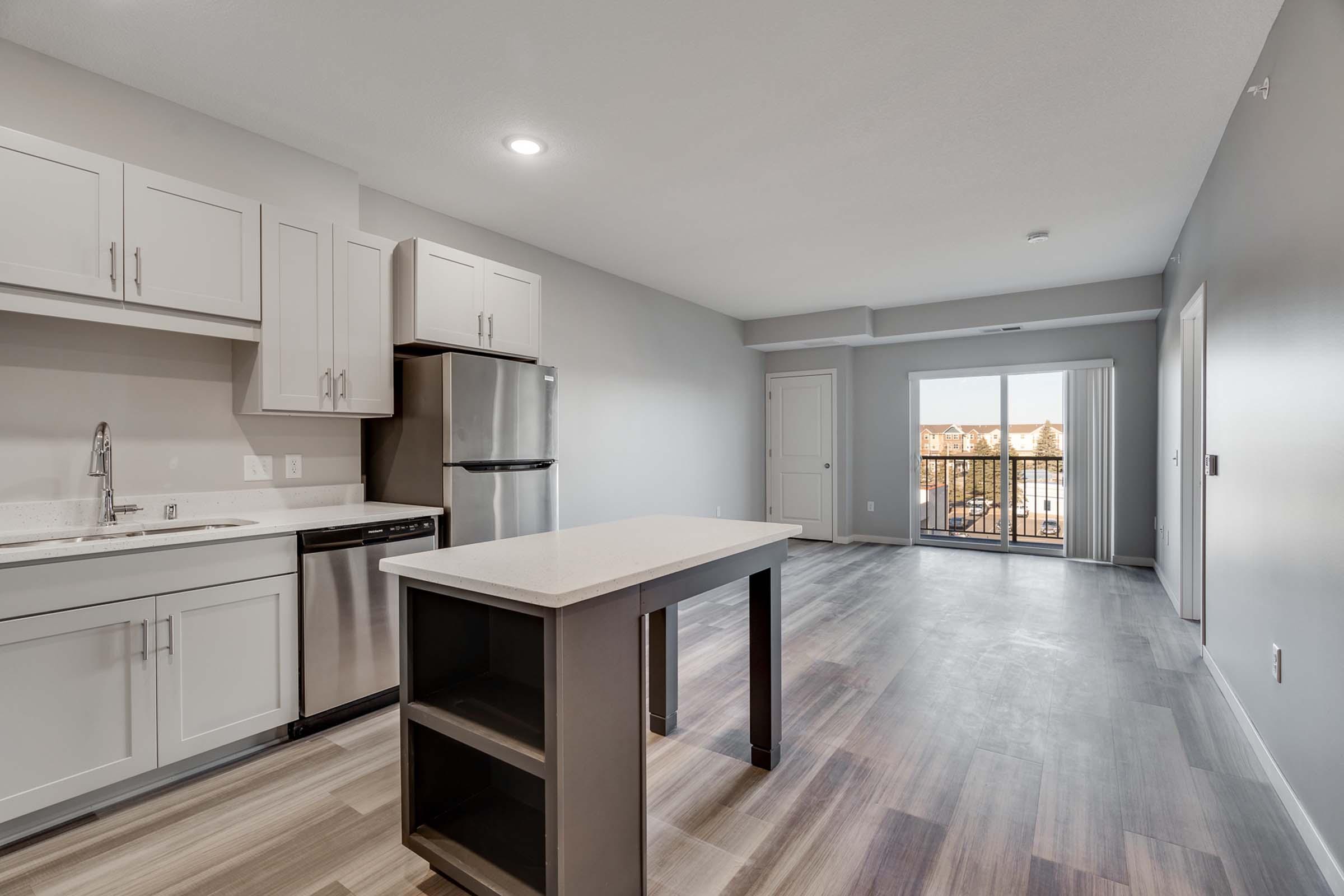 a kitchen with an island in the middle of a room