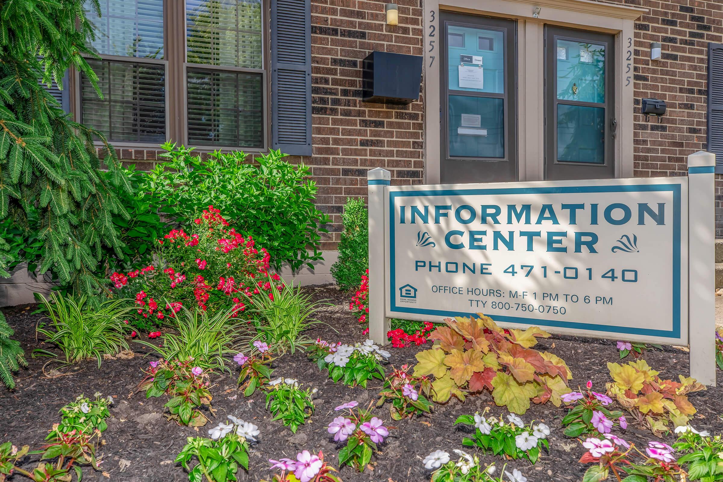 a sign in front of a brick building