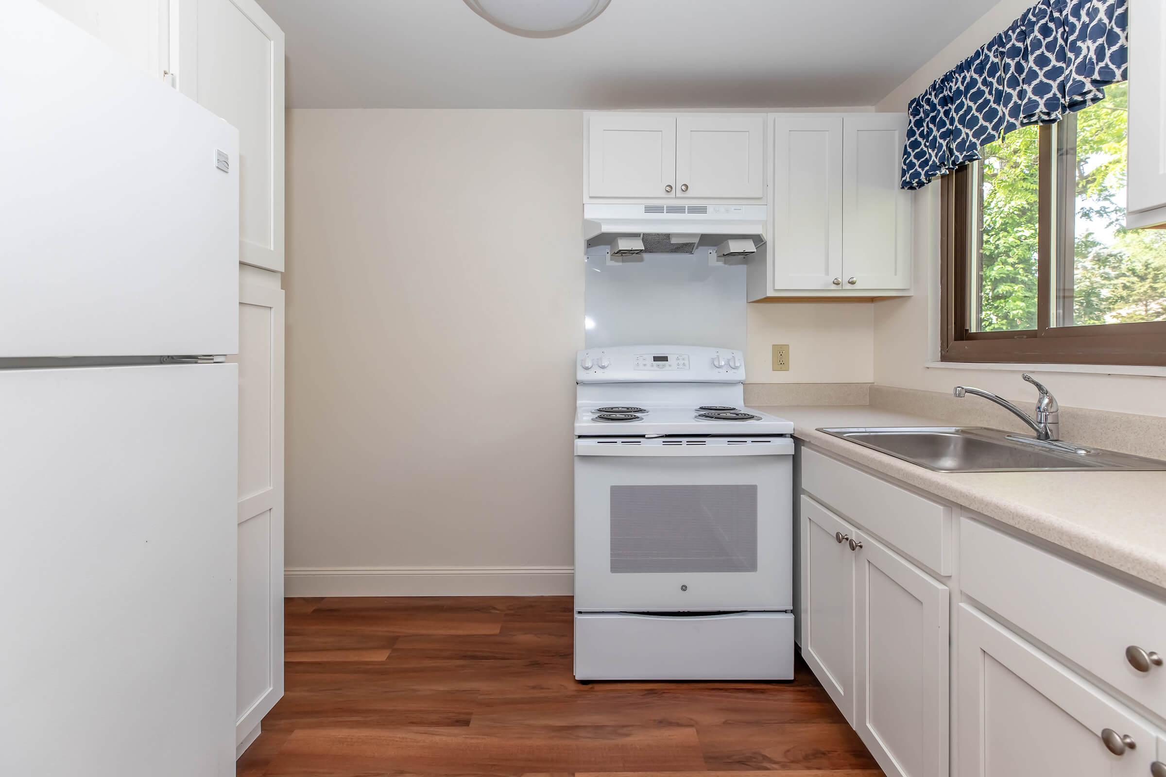 a kitchen with a stove sink and refrigerator