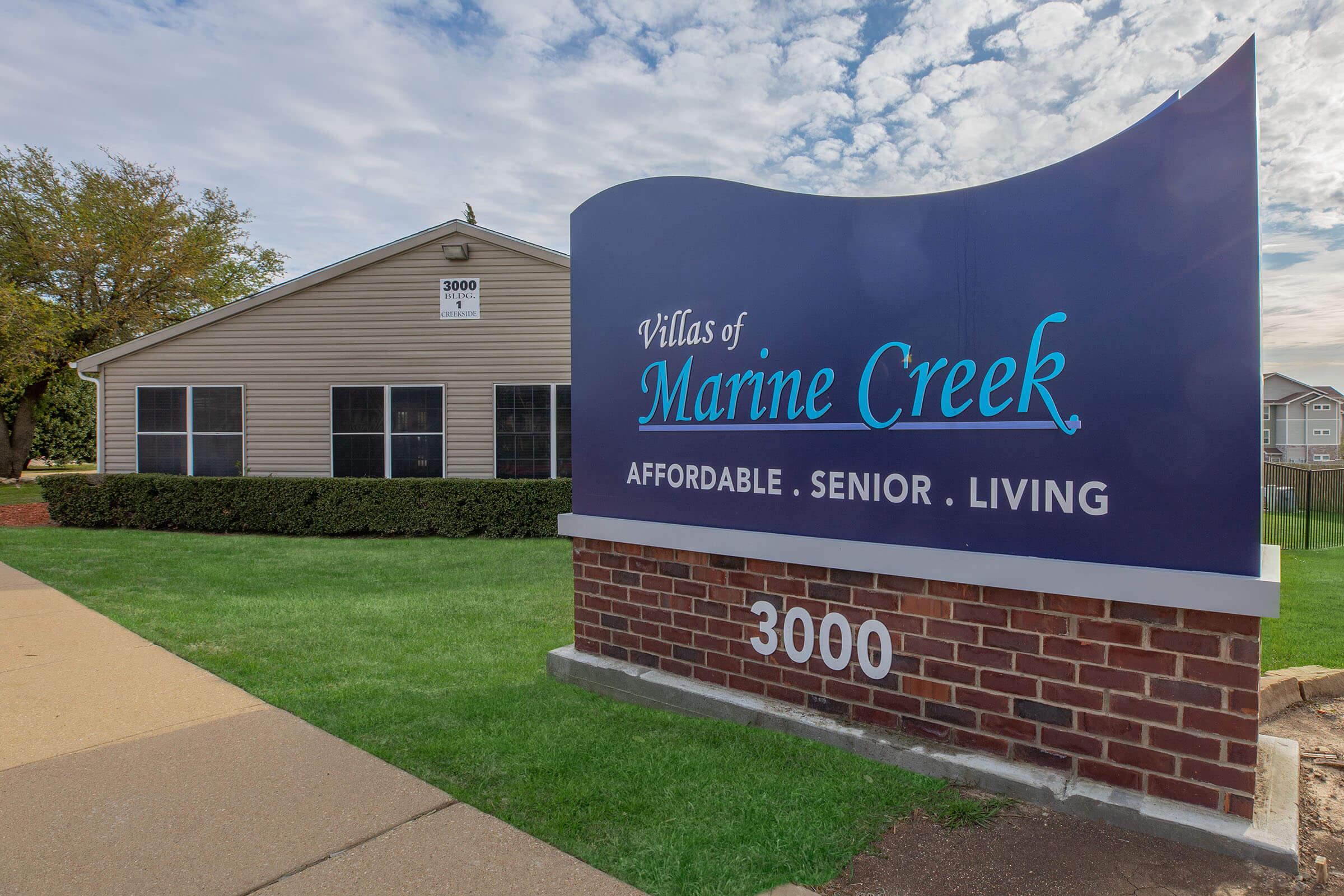 a sign in front of a brick building