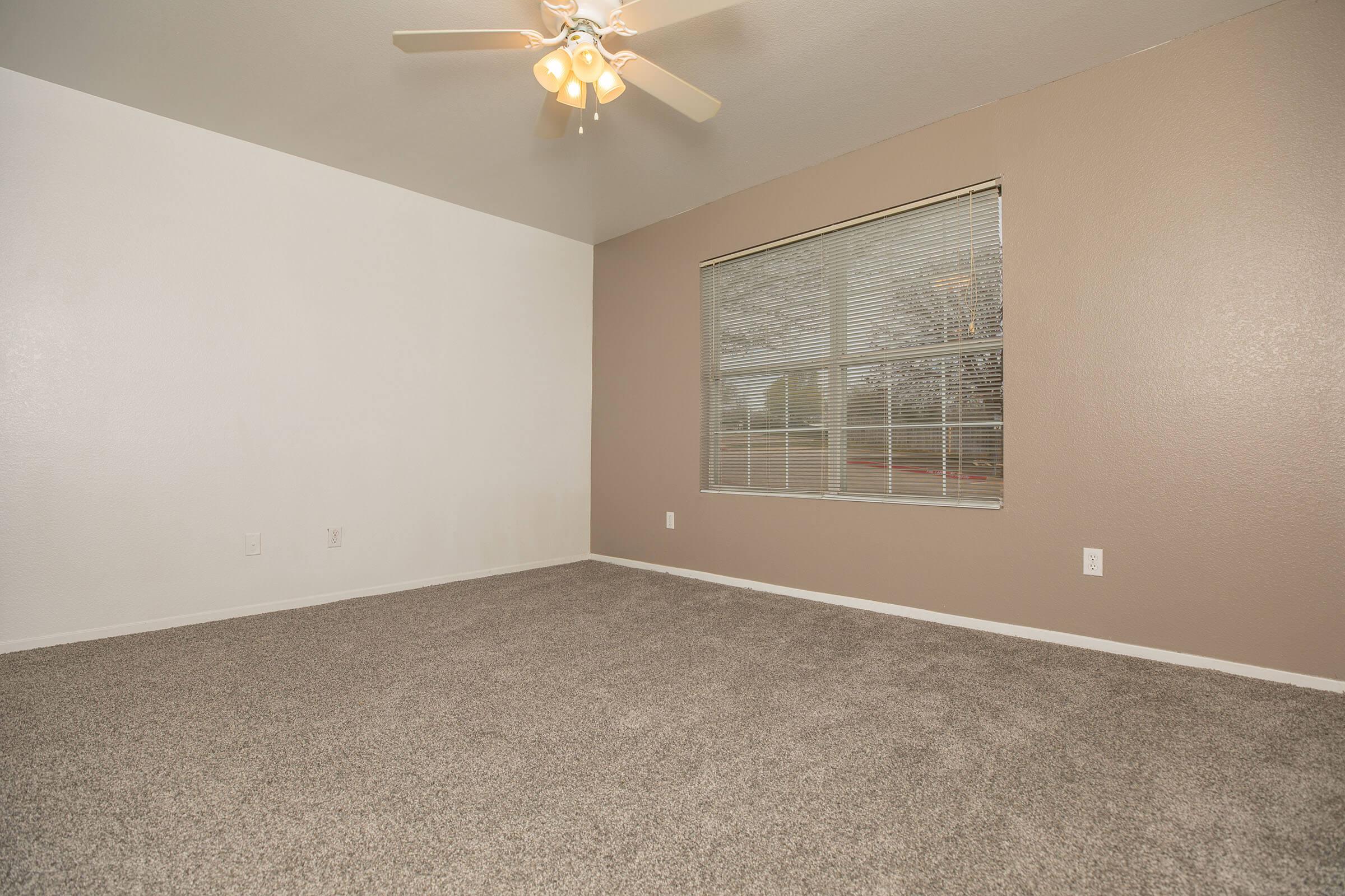 a bedroom with a bed and a mirror in a room