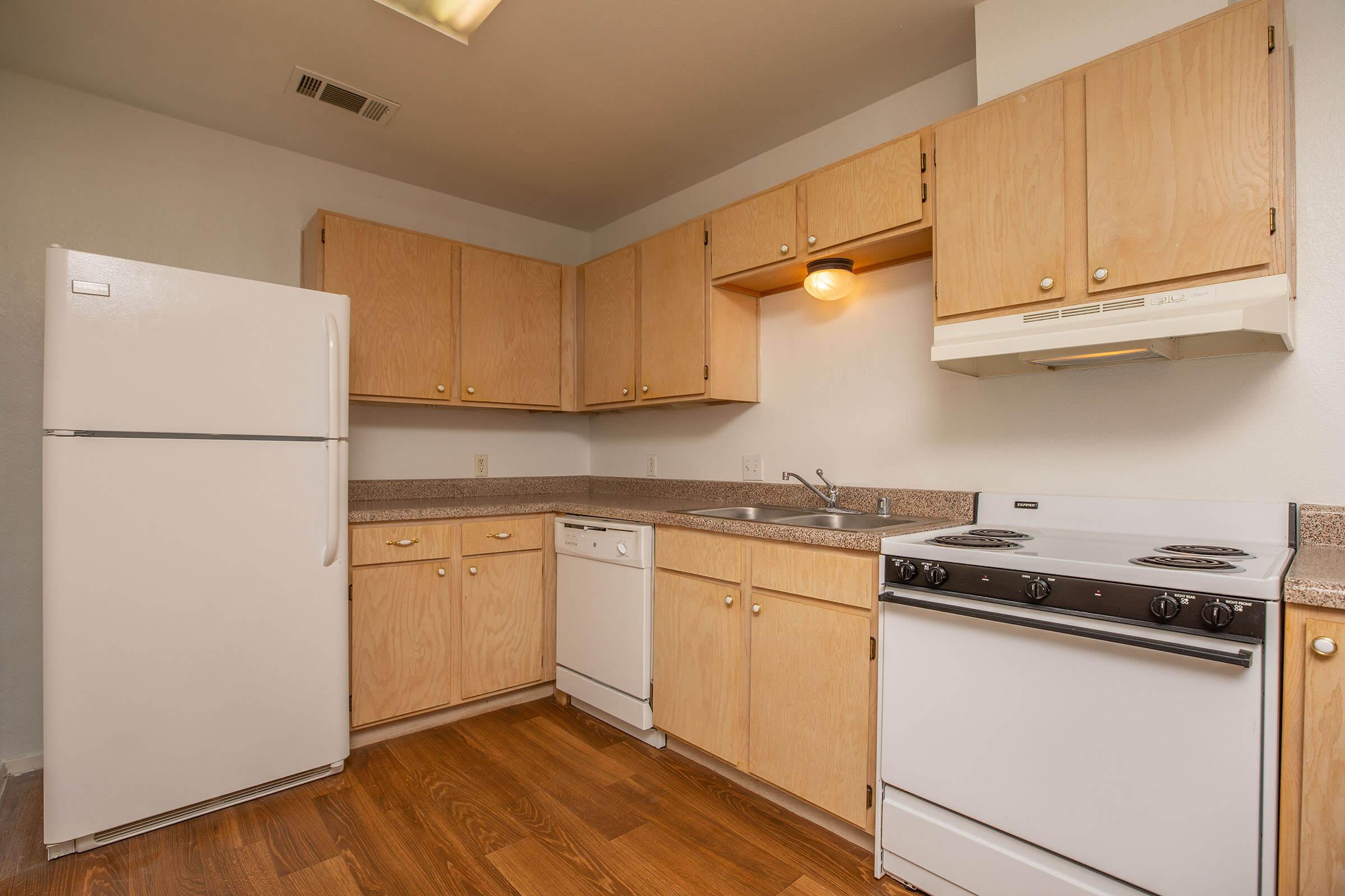 a kitchen with a stove and a refrigerator