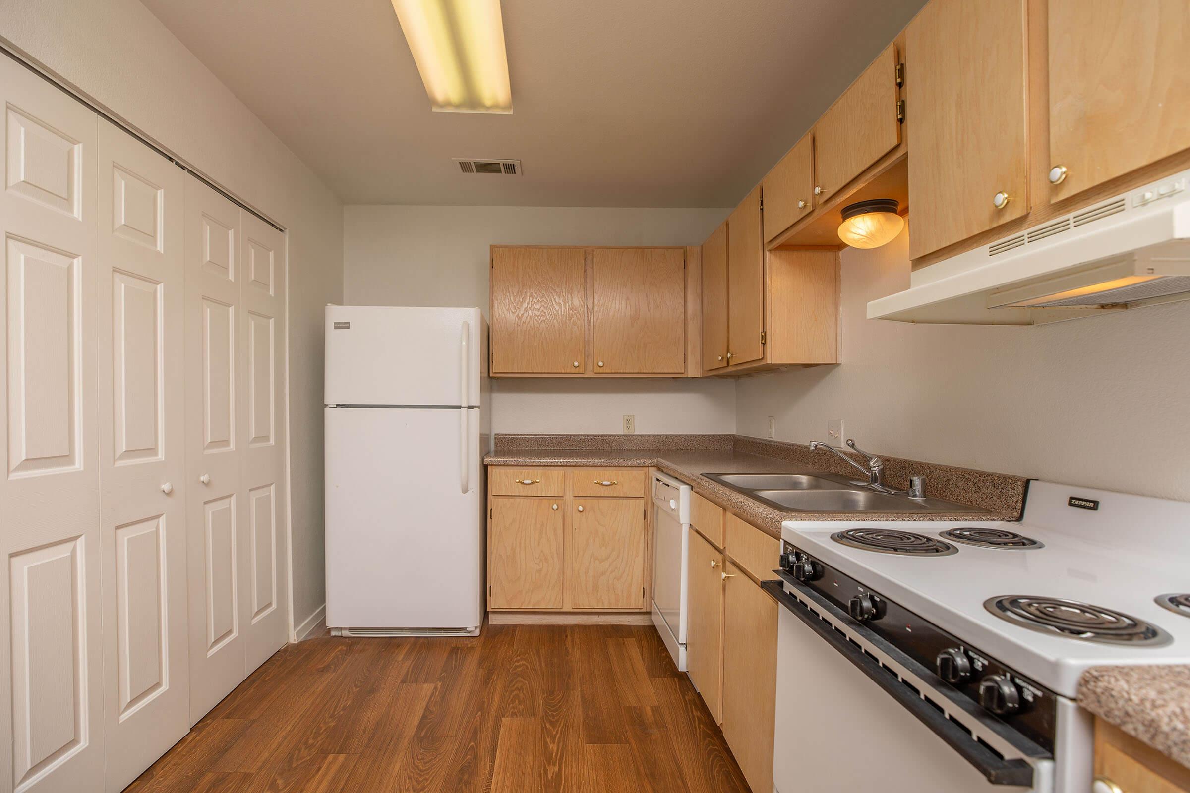 a kitchen with a stove and a refrigerator