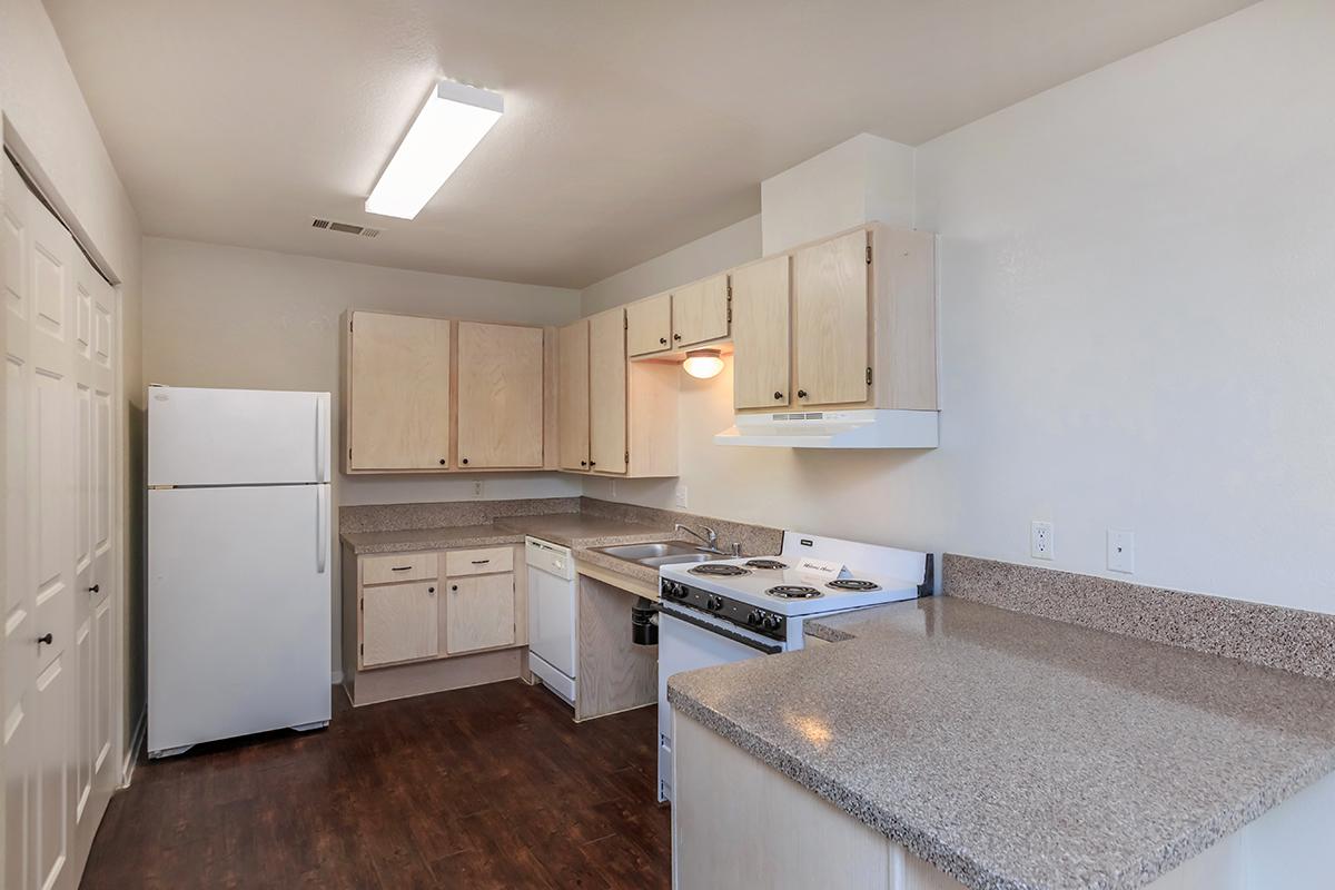 a kitchen with a stove sink and refrigerator