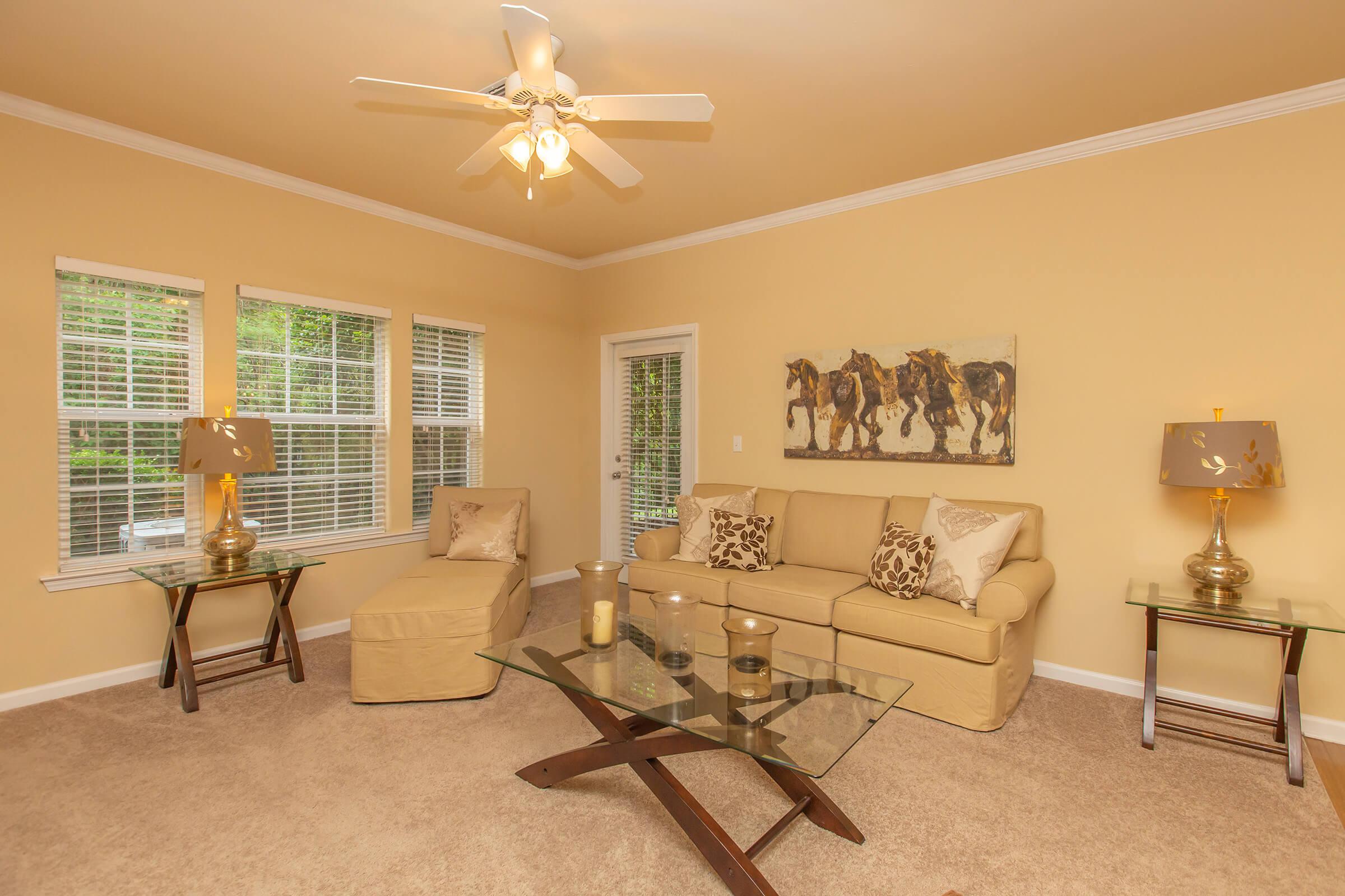 a living room filled with furniture and a large window