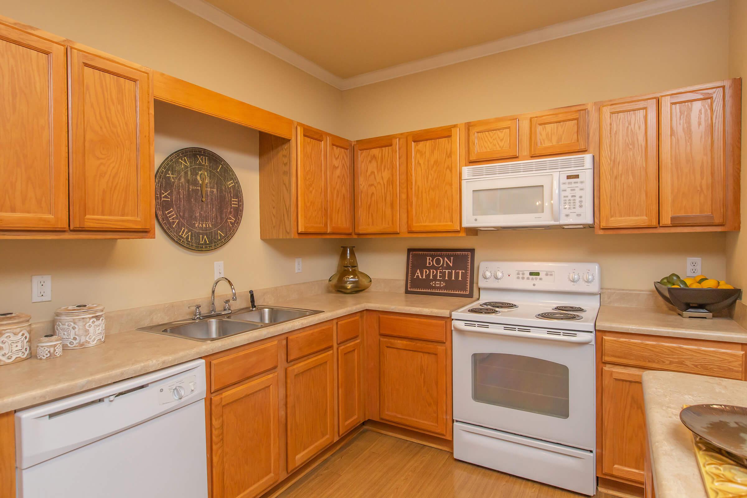 a kitchen with stainless steel appliances and wooden cabinets