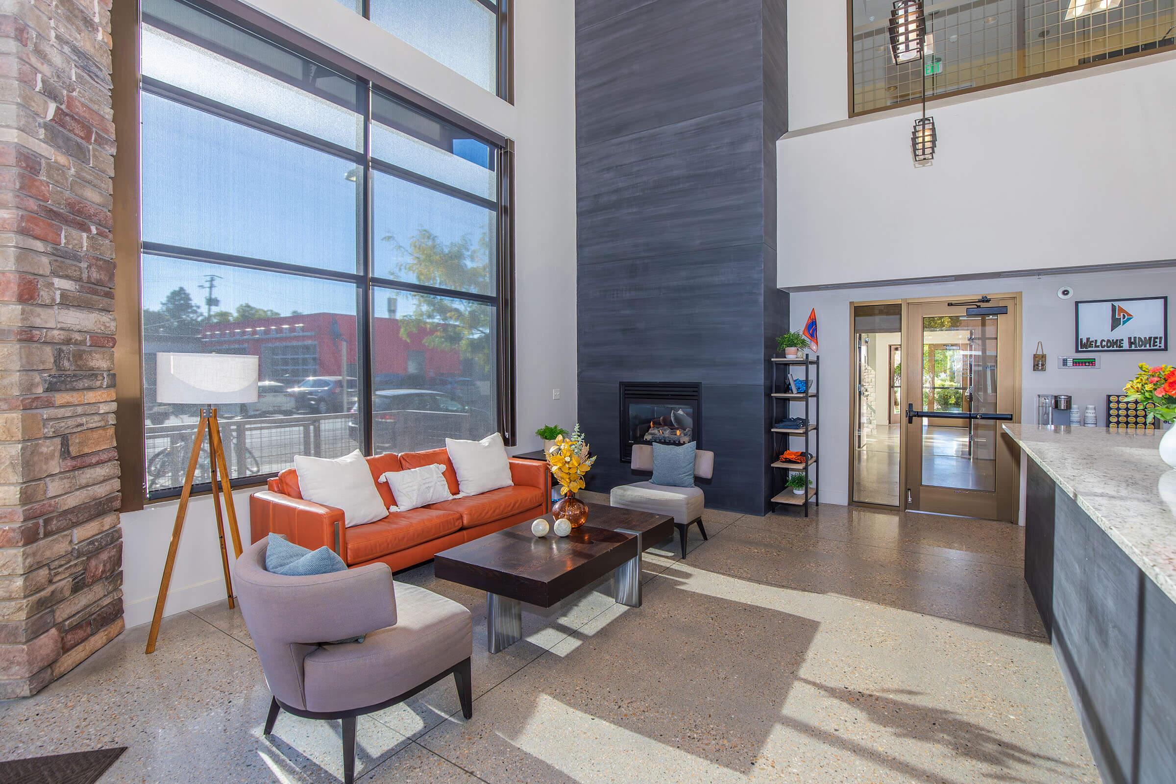 a living room filled with furniture and a large window