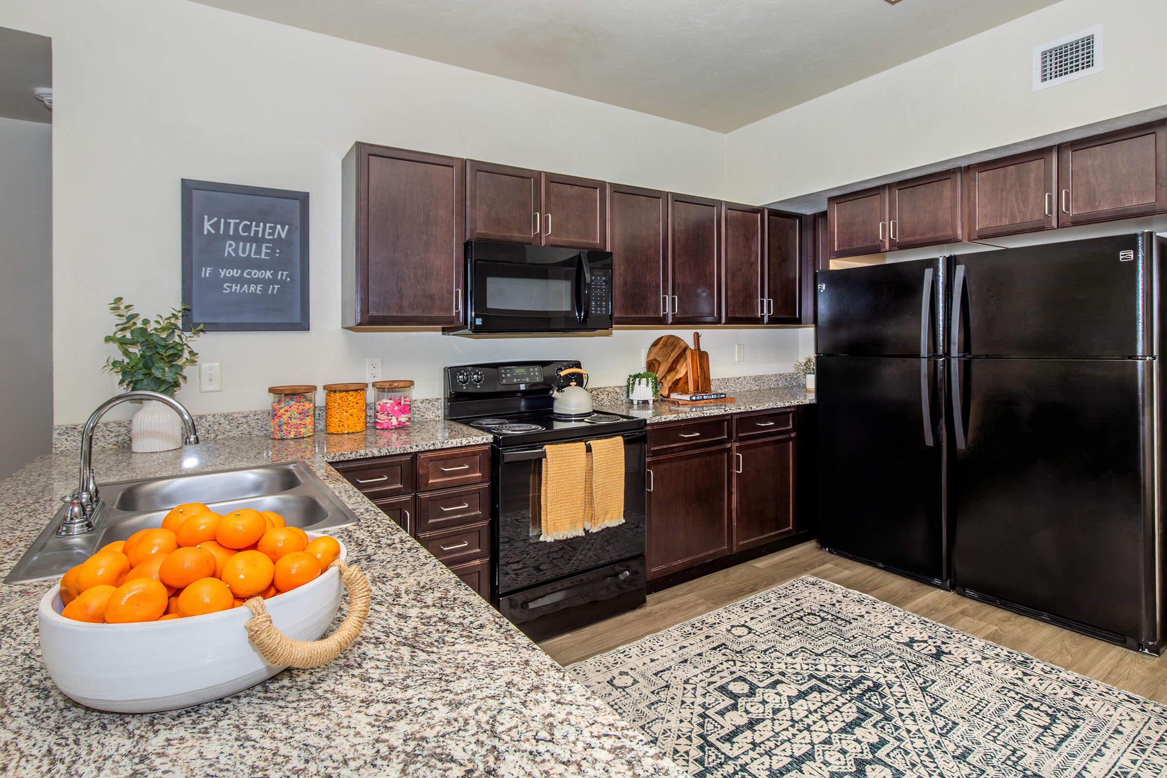 a kitchen filled with lots of oranges on a counter