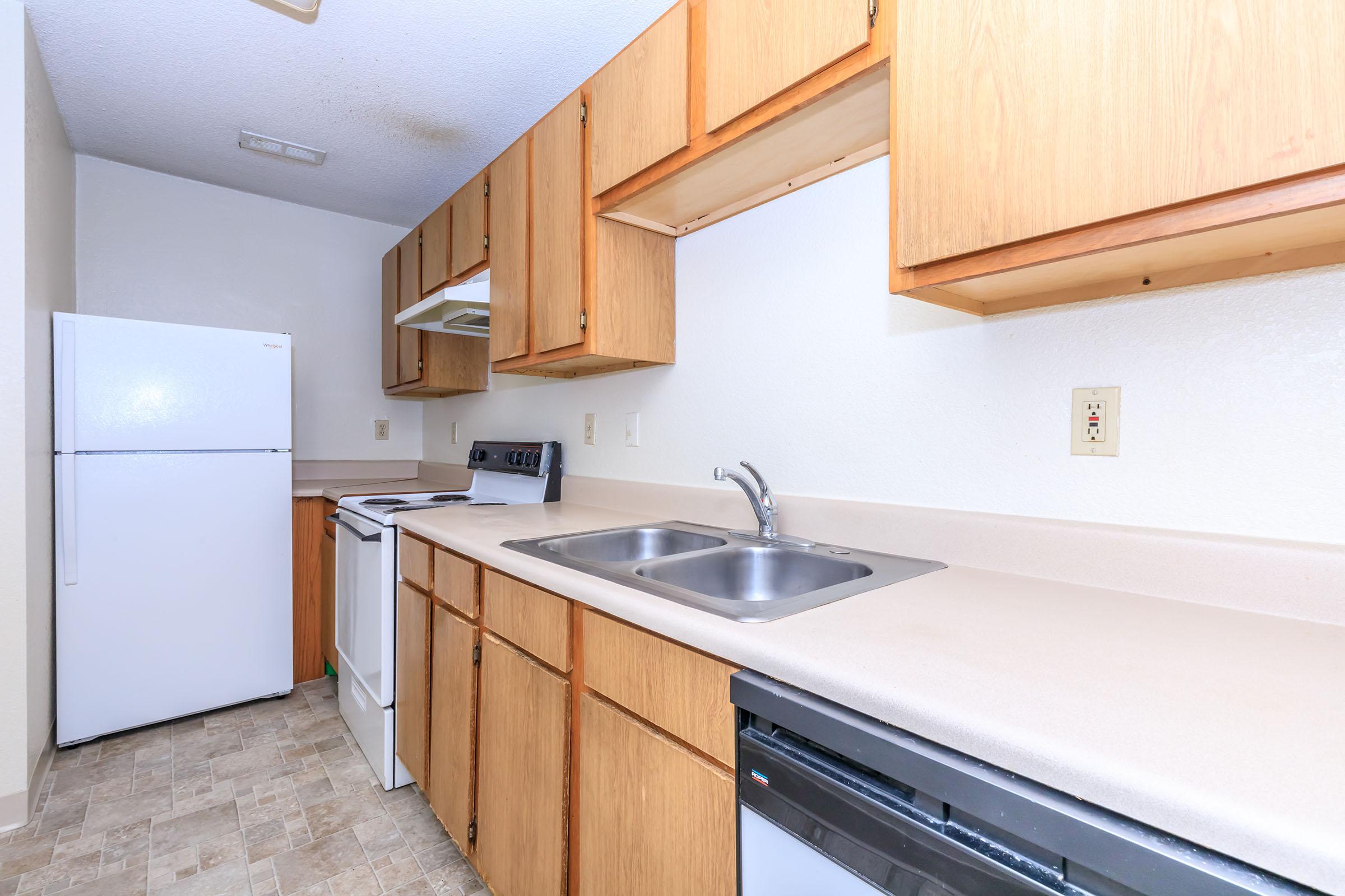 a kitchen with a stove sink and refrigerator