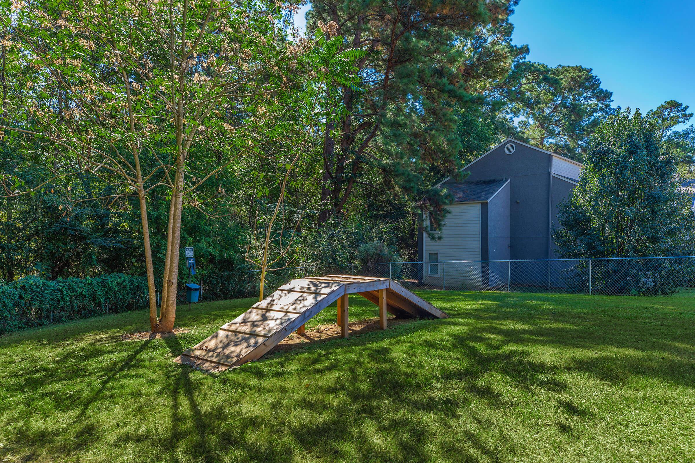 a couple of lawn chairs sitting on top of a lush green field