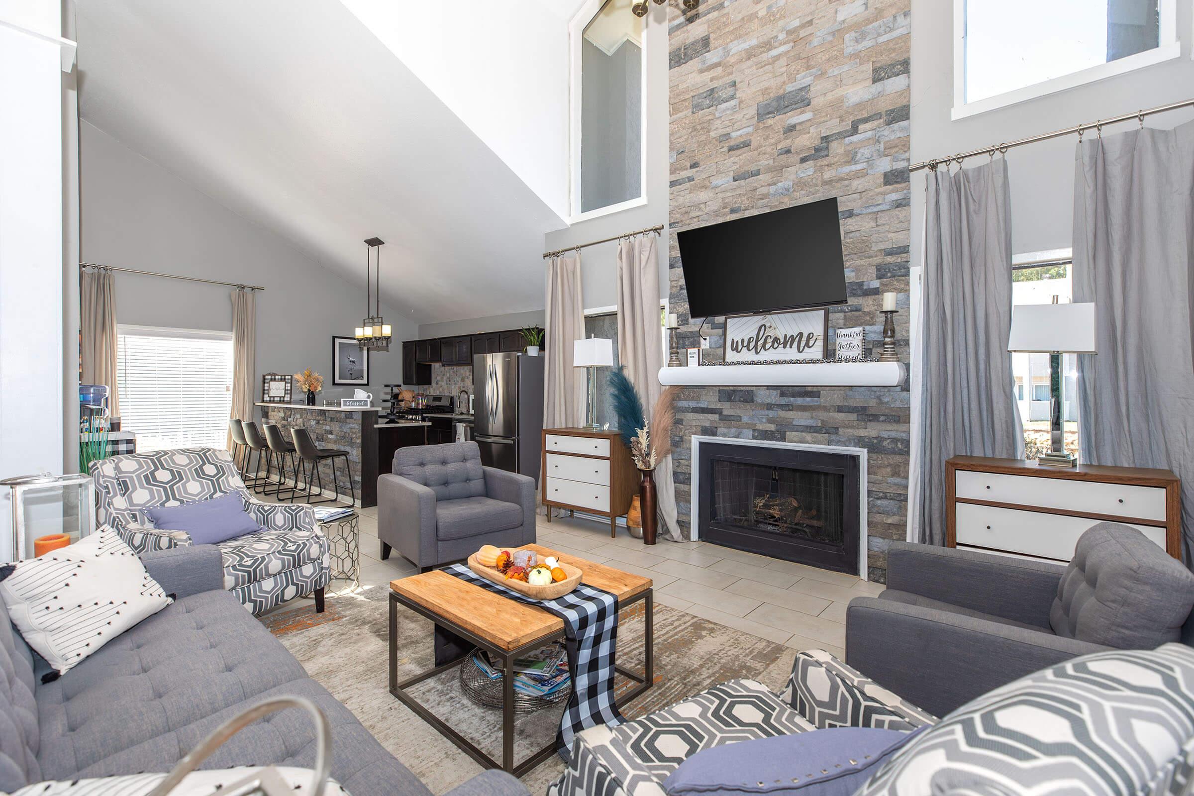 a living room filled with furniture and a fire place