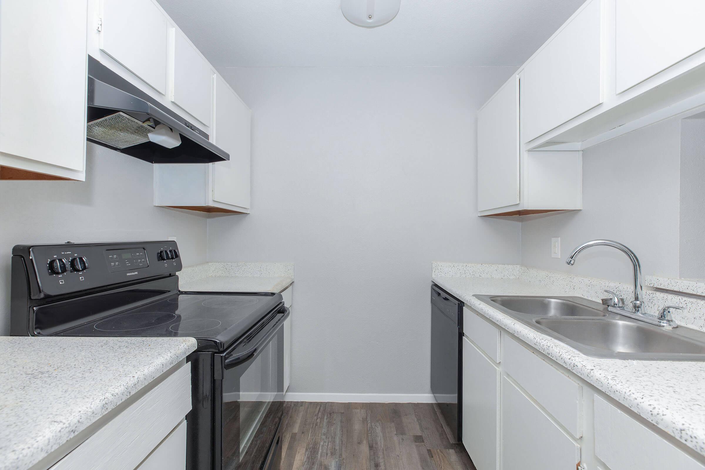 a kitchen with a sink and a mirror