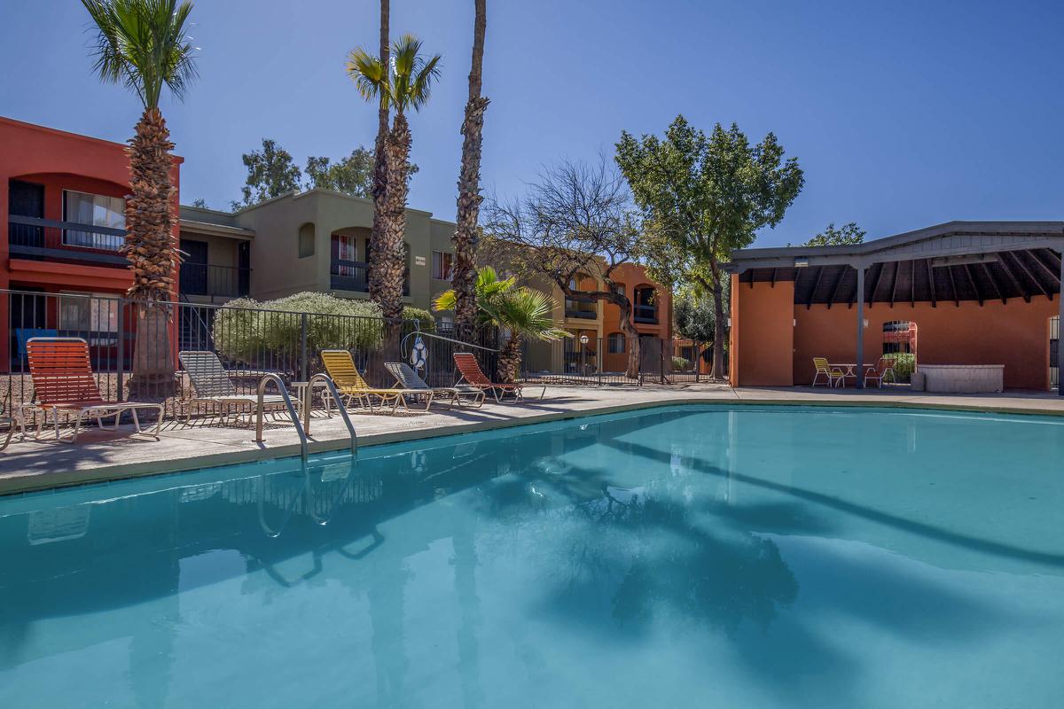 a house with a pool in front of a building