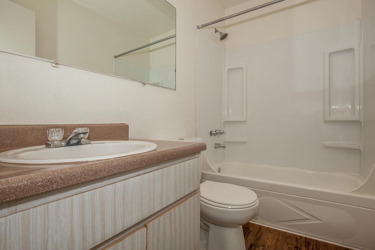 a white tub sitting next to a sink