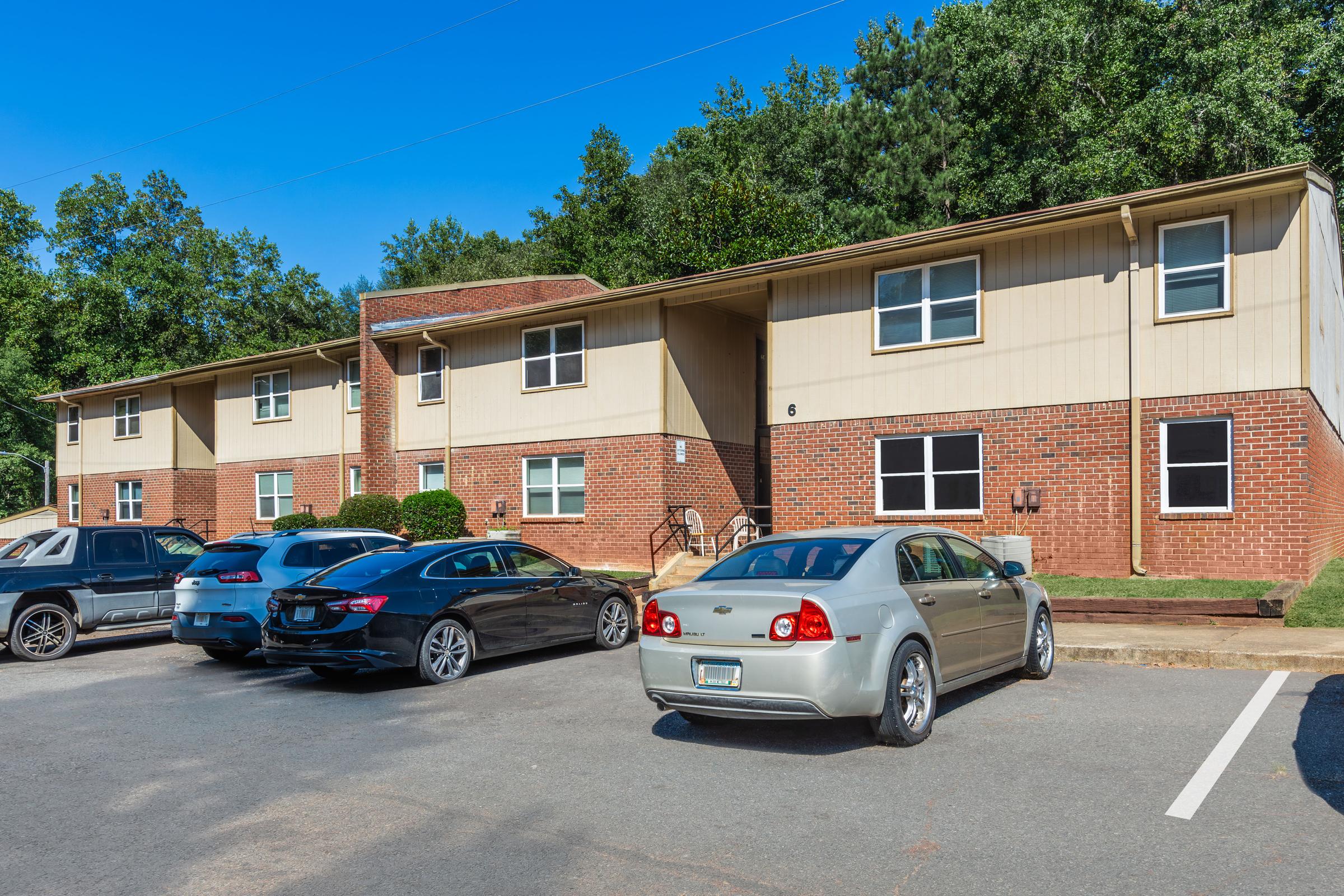 a car parked in a parking lot in front of a house