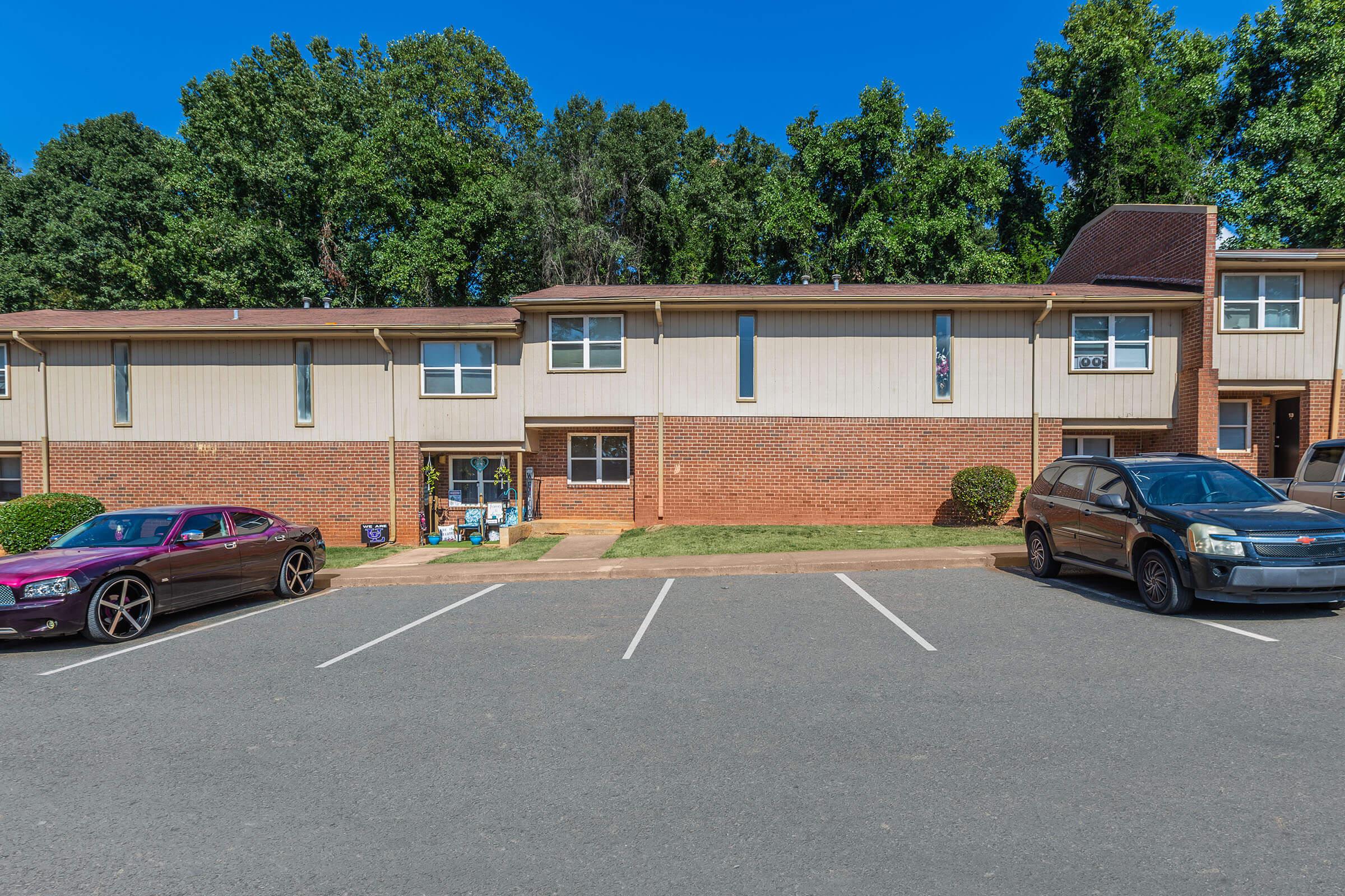 a car parked in a parking lot in front of a house