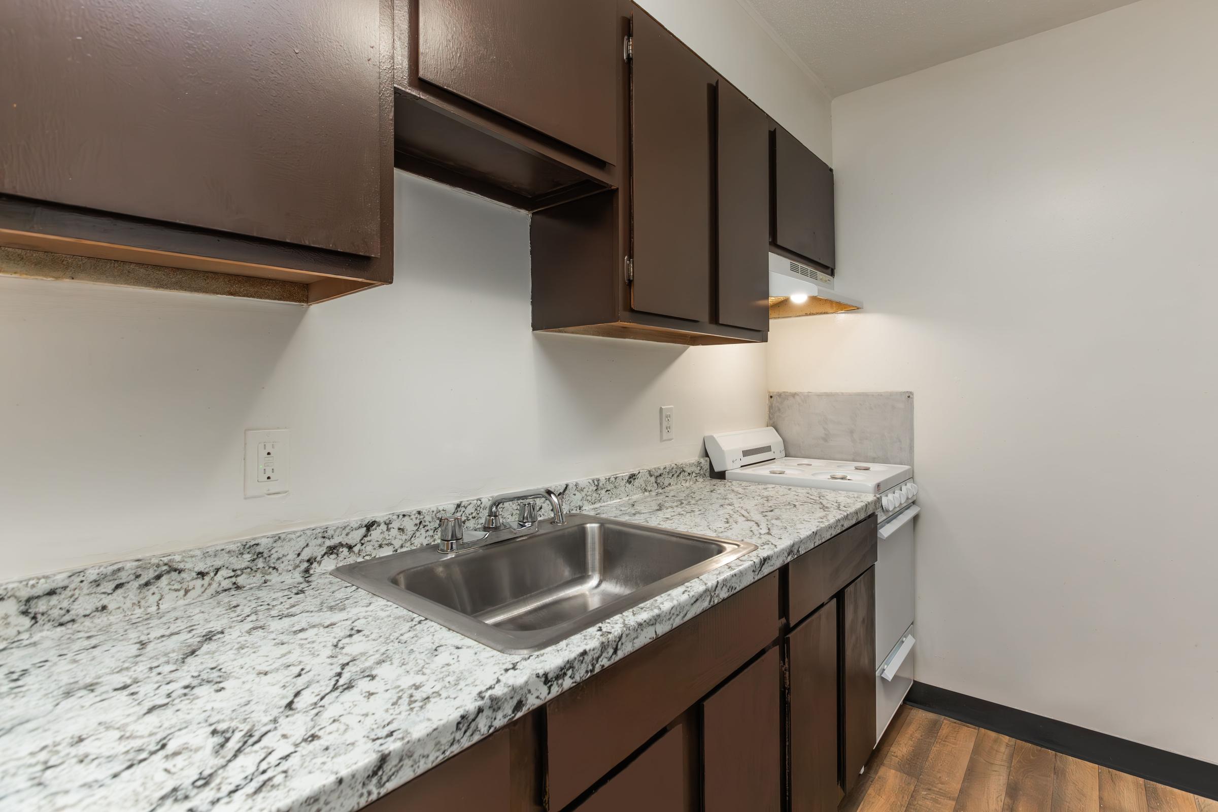 a kitchen with a sink and a mirror