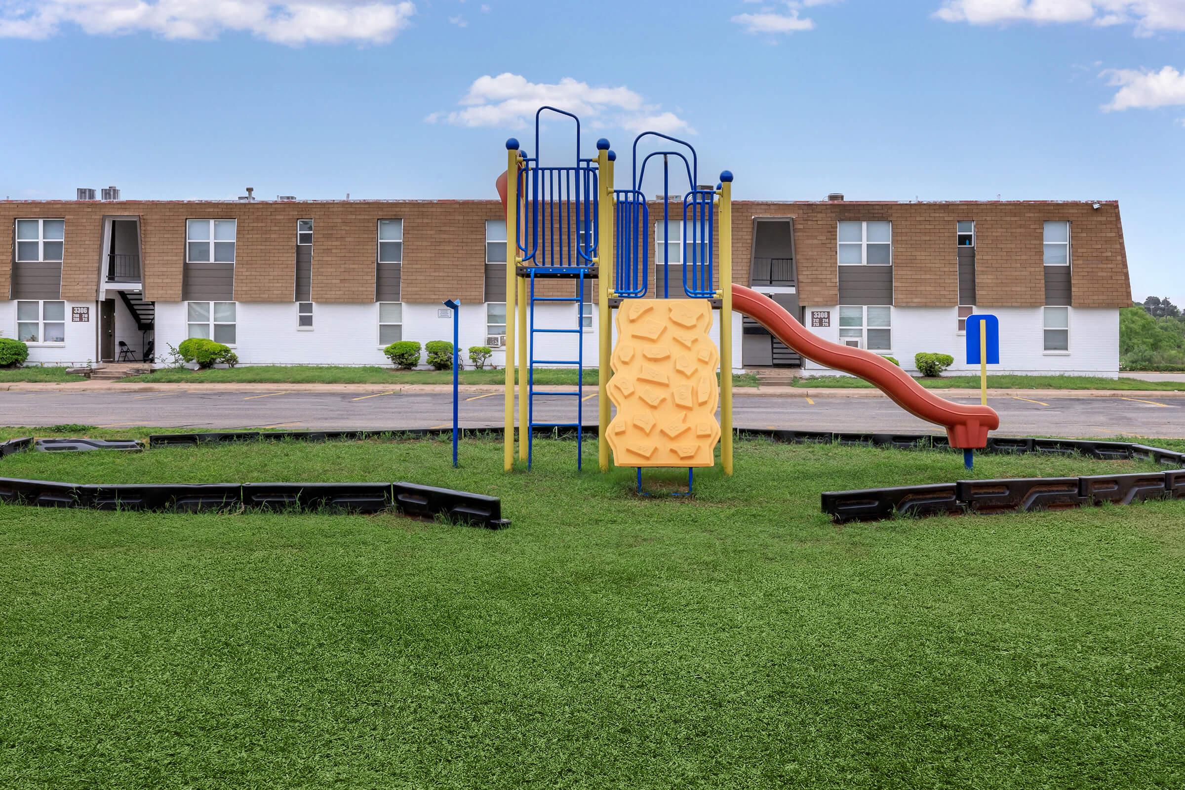 a green lawn in front of a building