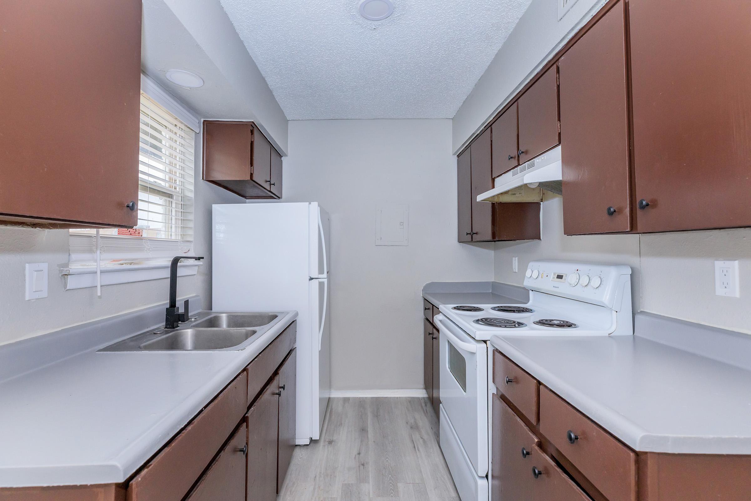 a kitchen with a stove sink and refrigerator