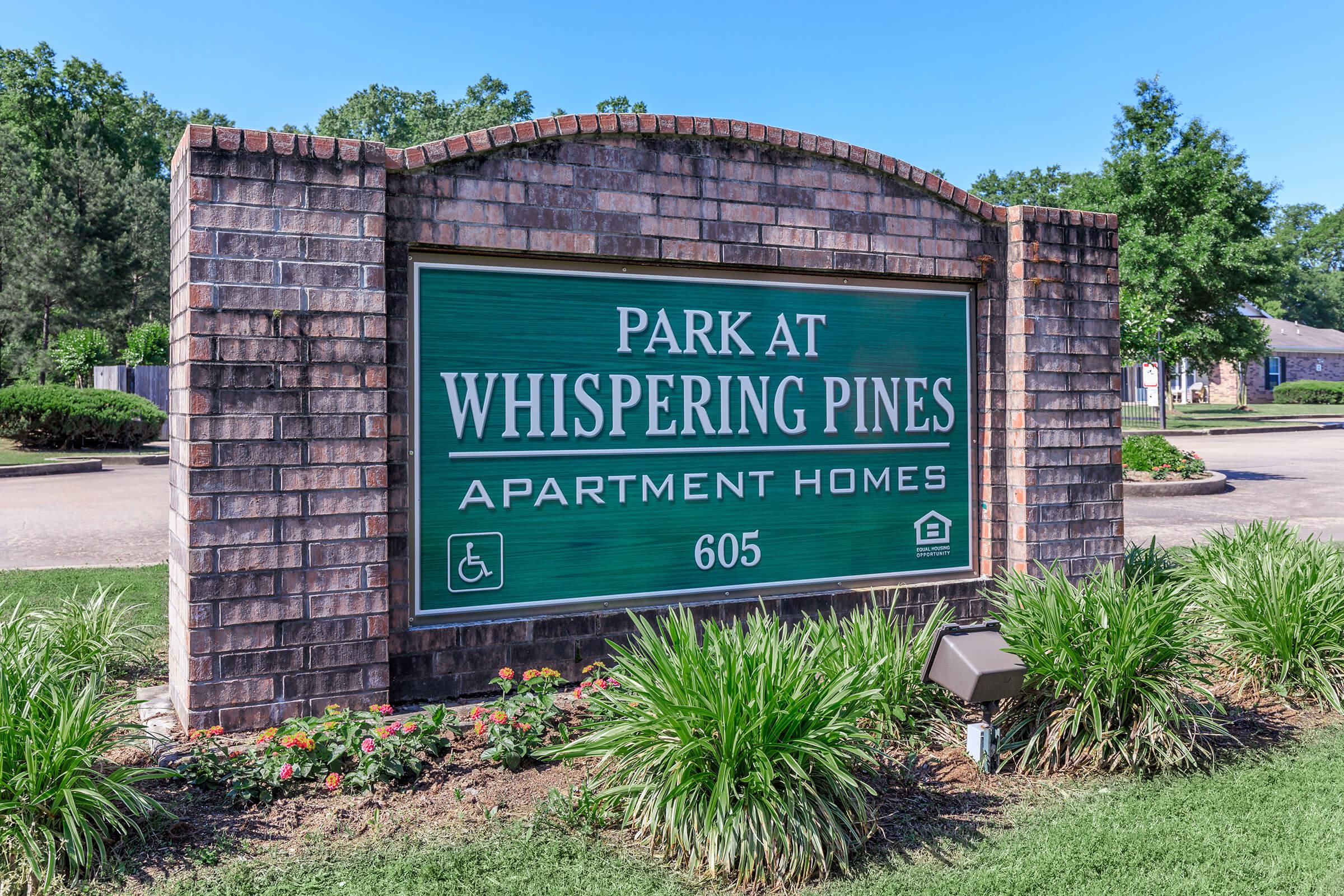 a green and white street sign sitting on the side of a building