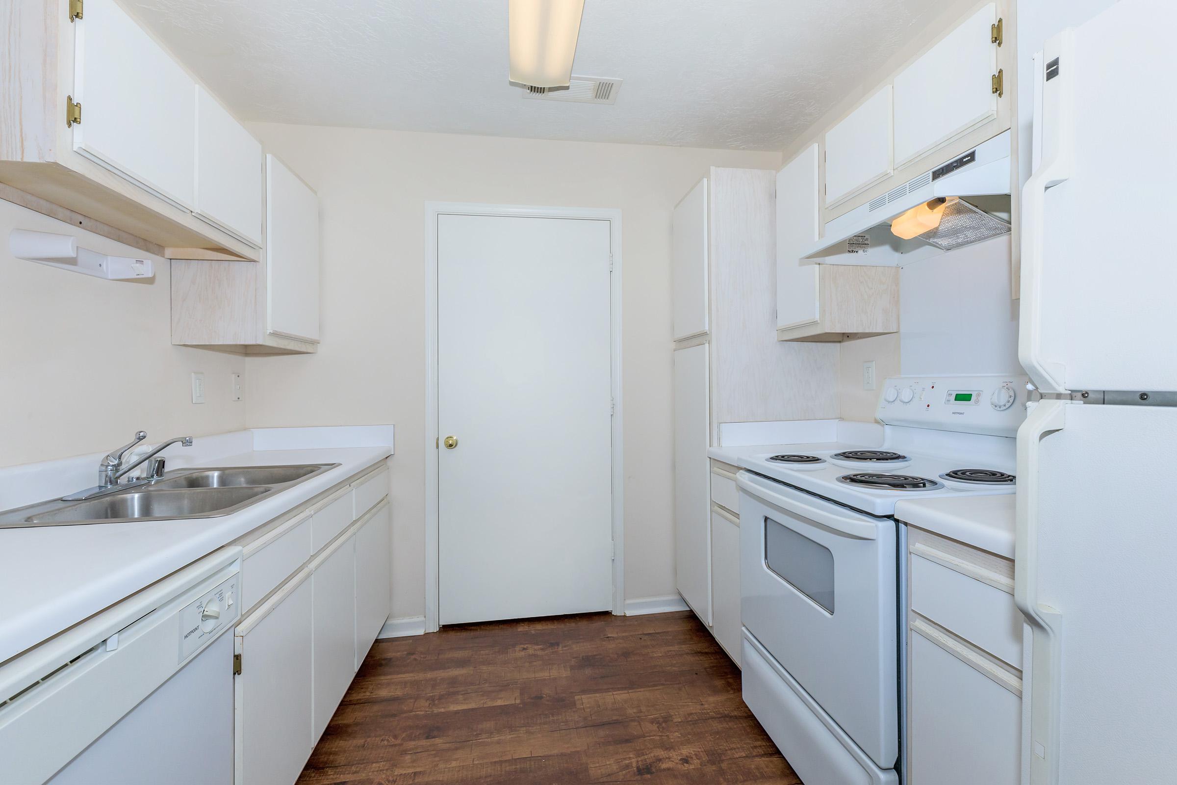 a kitchen with white cabinets and a sink