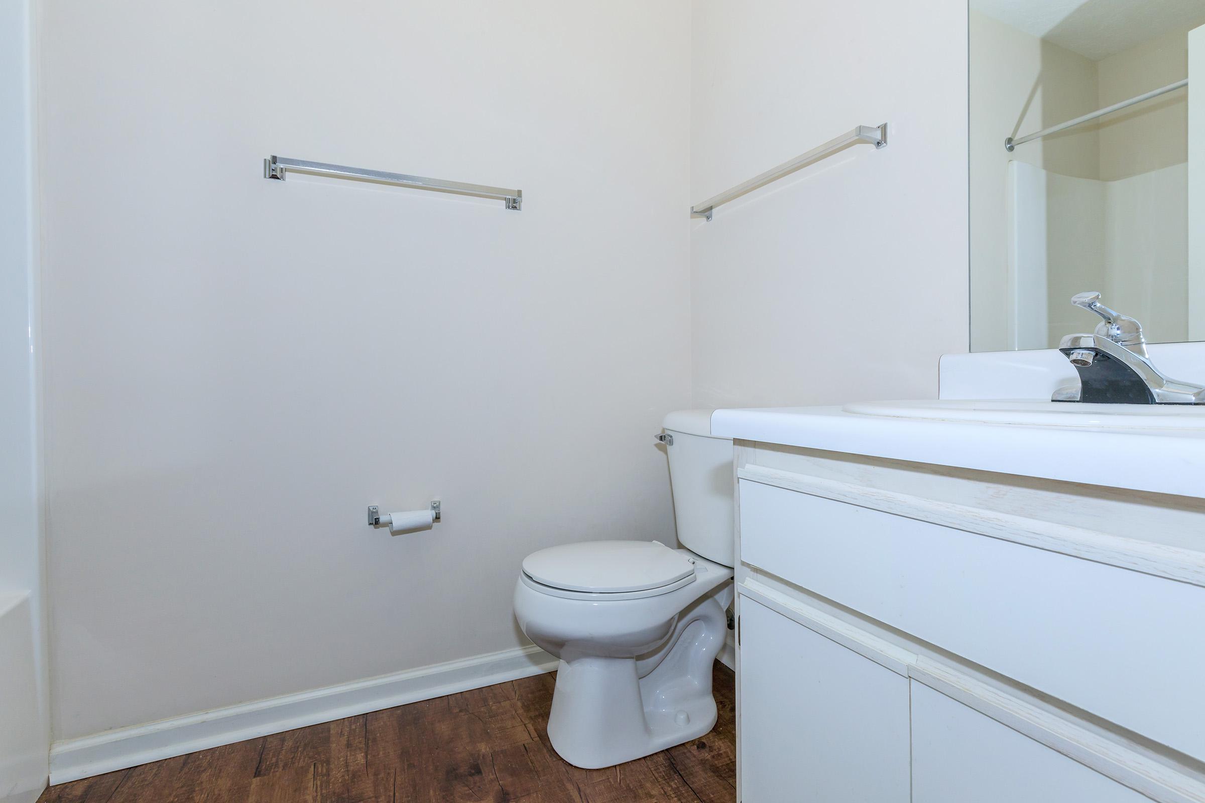 a white sink sitting next to a shower