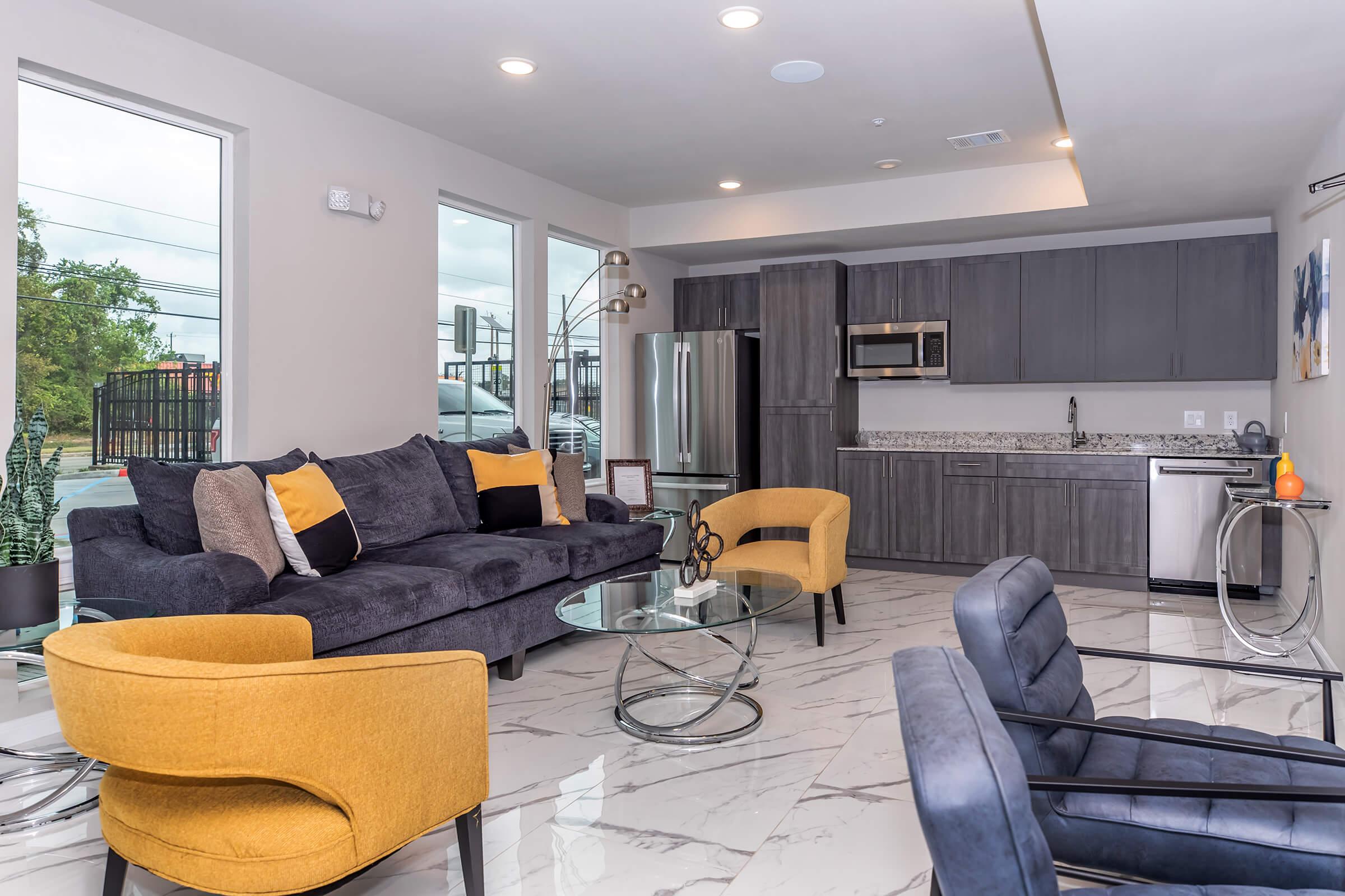 a living room filled with furniture and a large window